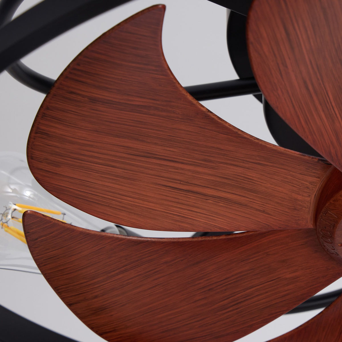 Close-up of wood-grain fan blades — rich walnut texture, curved aerodynamic shape, exposed E26 bulb, rustic farmhouse detail | Sofary Lighting