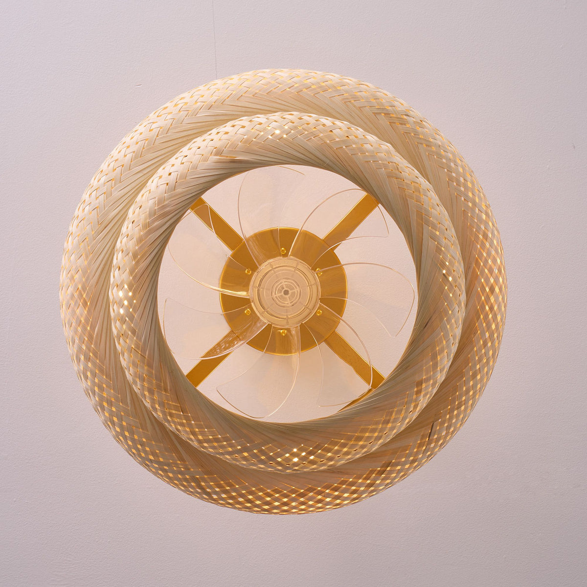 Top/underside view of rustic fandelier — double-layer rattan weave, brass gold motor center, clear blades, circular cage ceiling fan design | Sofary Lighting