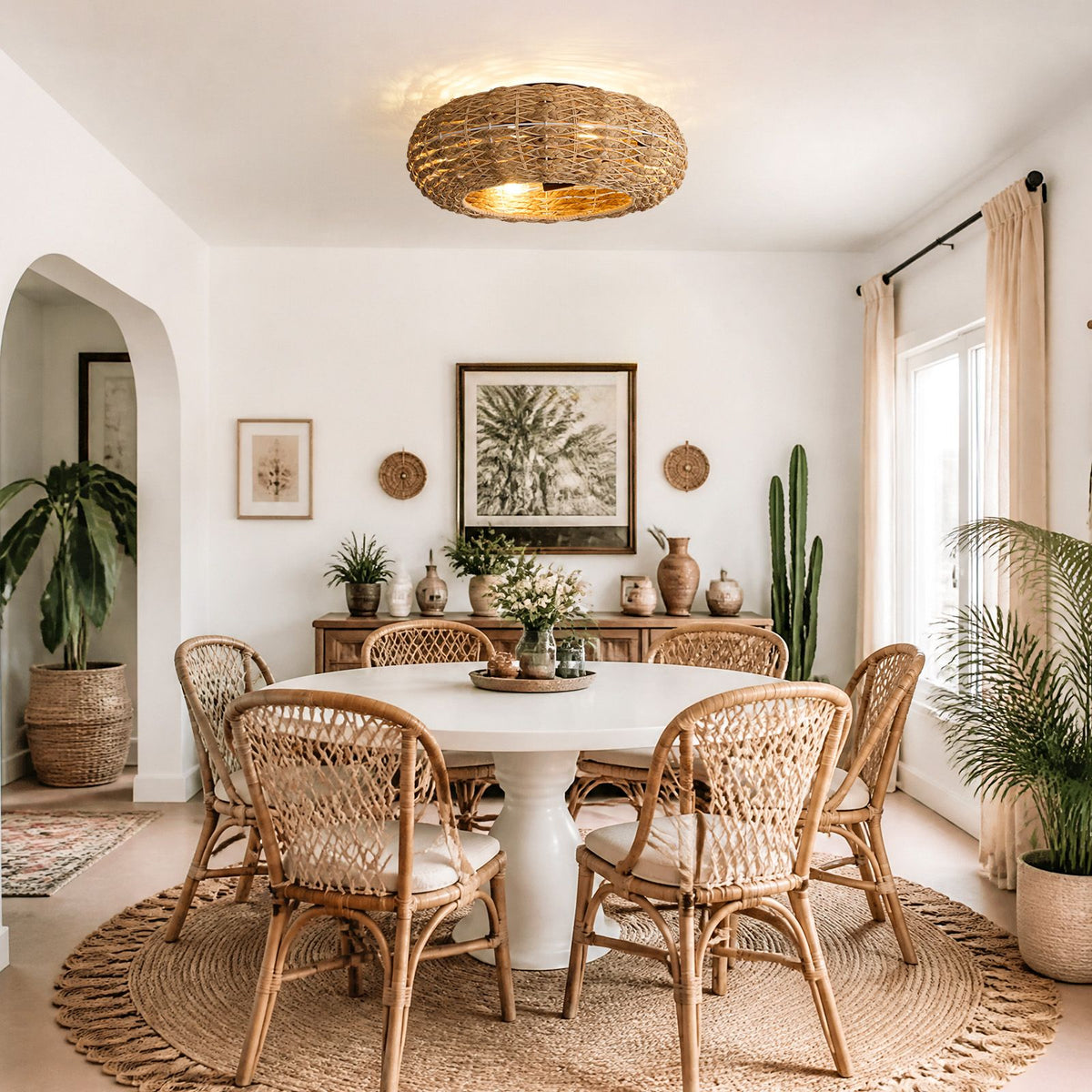 Boho rattan fan in dining room — round table, rattan chairs, palm art, warm woven shade light, coastal boho decor | Sofary Lighting