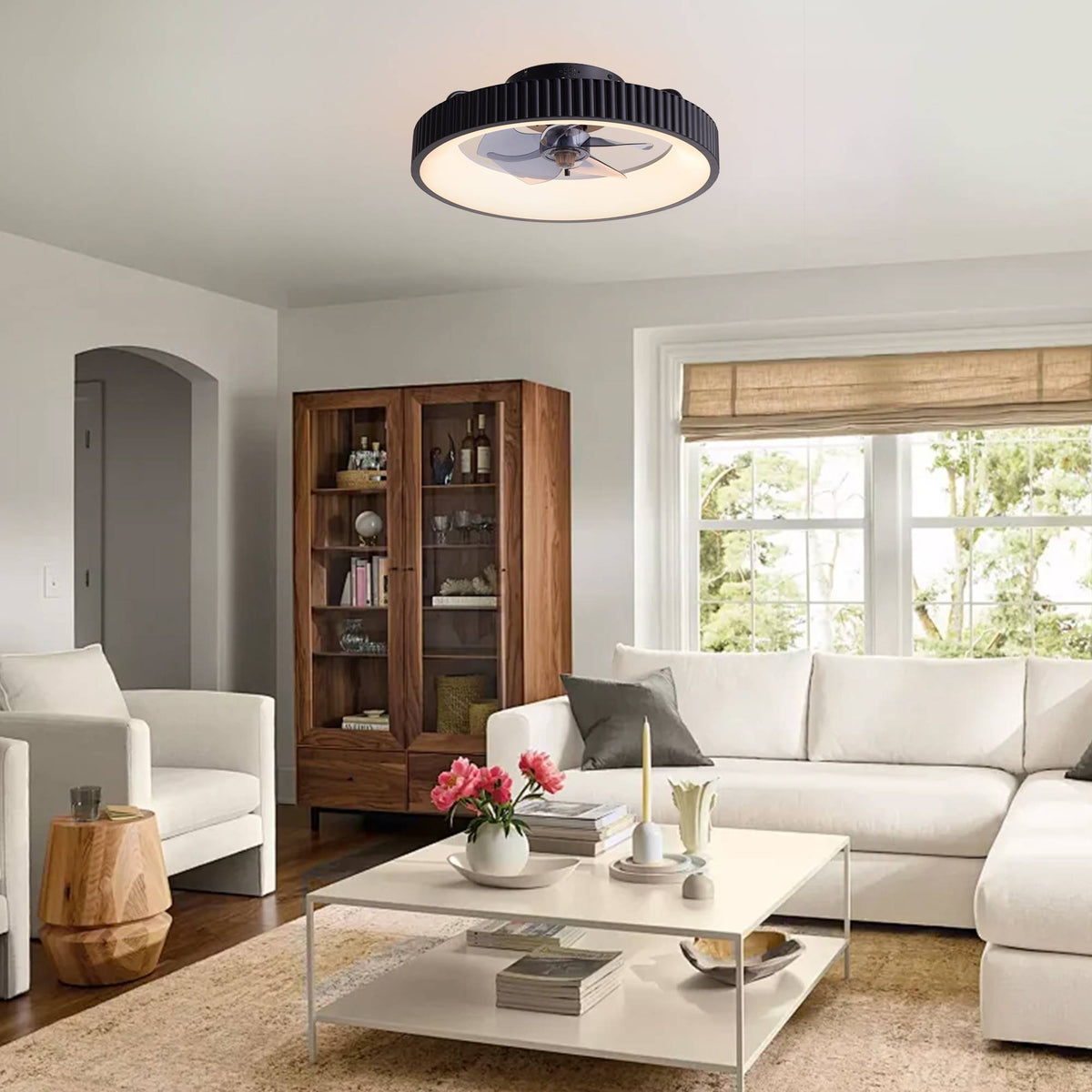 Modern flush mount ceiling fan in living room — white sofa, wooden cabinet, coffee table, bright windows, low profile fan with LED light
