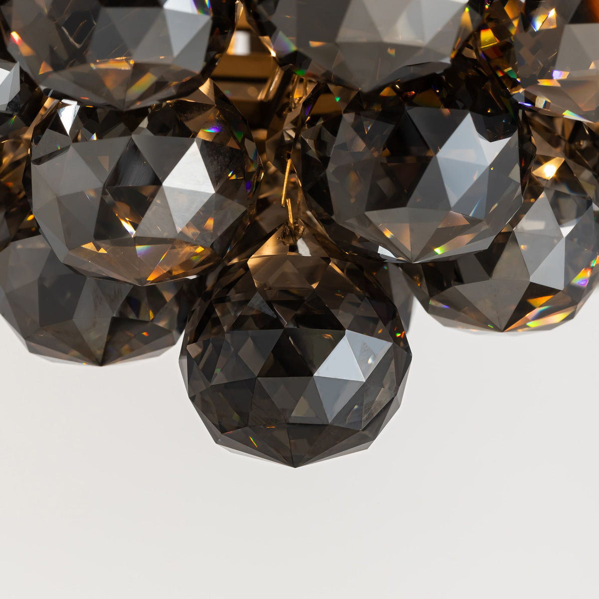 Macro crystal detail of fandelier — smoked K9 crystals, light refraction, premium 36" retractable LED ceiling fan | Sofary Lighting
