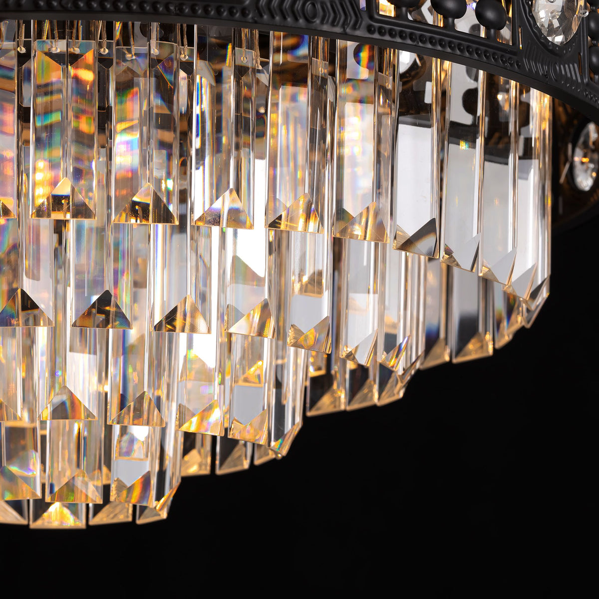 Close-up of black crystal ceiling fan — tiered rectangular and faceted crystal pendants, light refraction with golden and rainbow reflections, black metal frame, dark background | Sofary Lighting