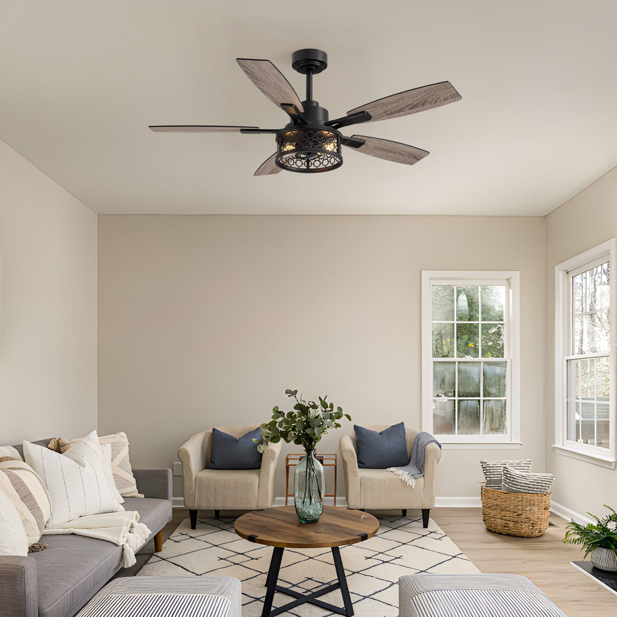 Farmhouse caged ceiling fan in living room — beige sofa, woven basket, geometric rug, warm rustic modern decor | Sofary Lighting