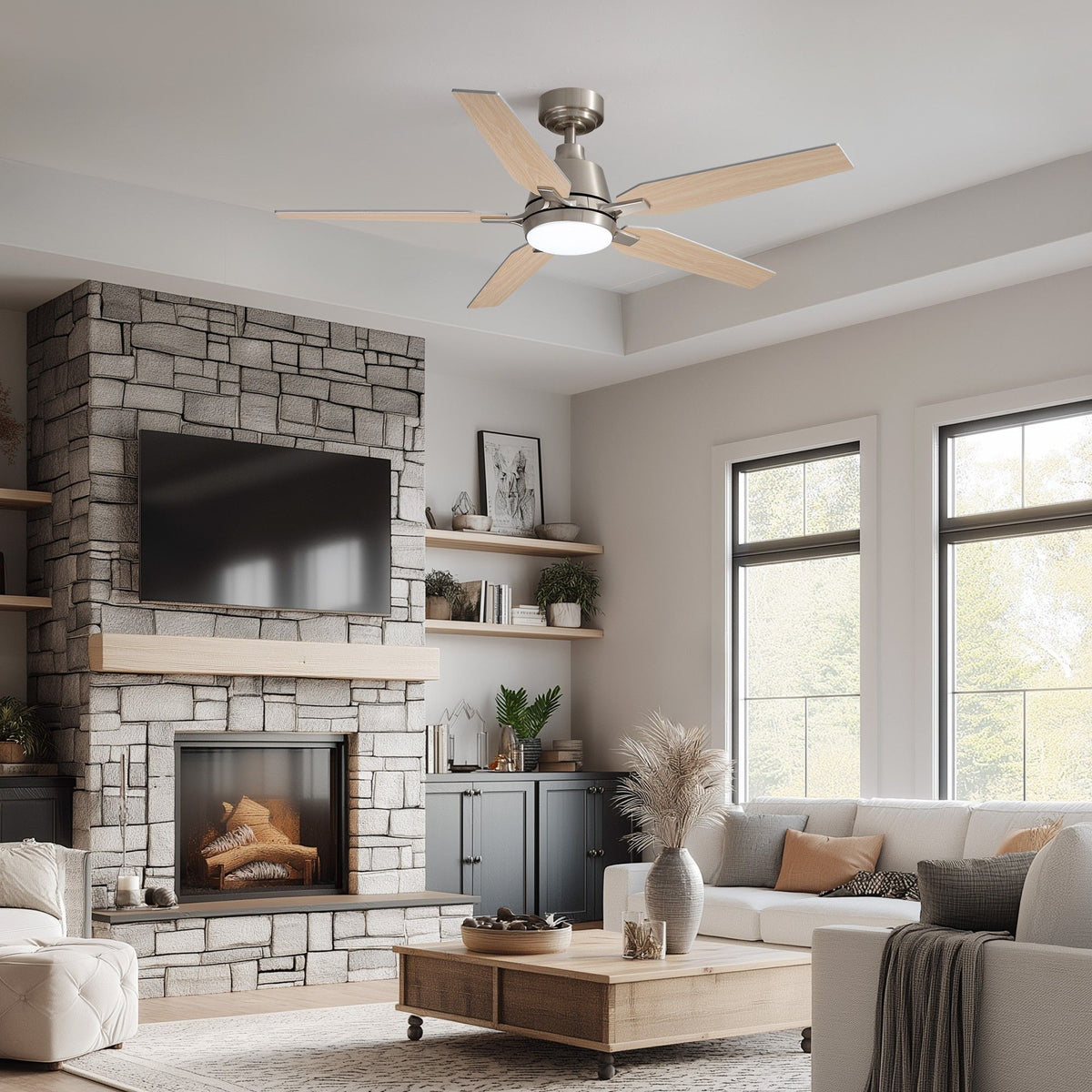 Brushed nickel ceiling fan in modern farmhouse living room — stone fireplace, wall TV, white sofa, wooden coffee table, large windows, warm LED glow | Sofary Lighting