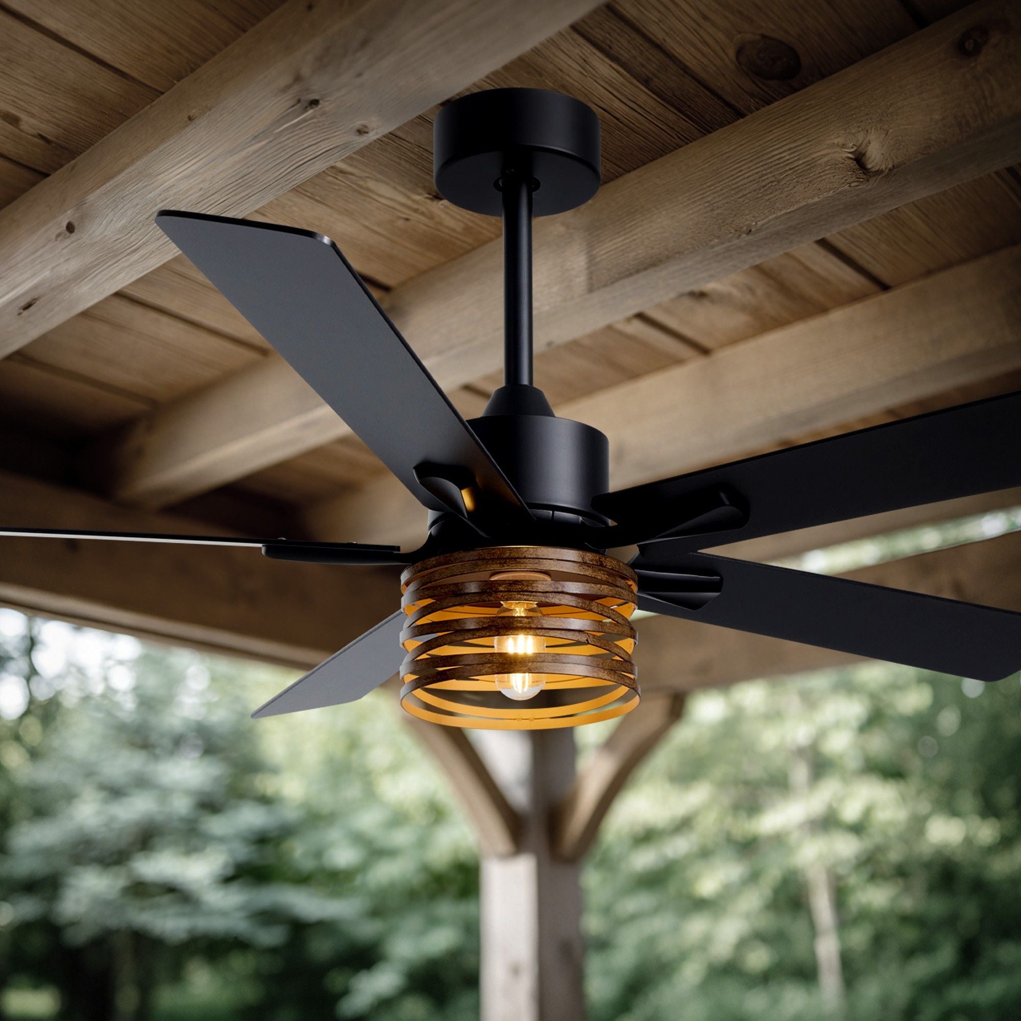 Industrial farmhouse ceiling fan outdoor patio — wood plank ceiling, black metal frame, amber glass light shade, lush green garden background, warm glow | Sofary Lighting