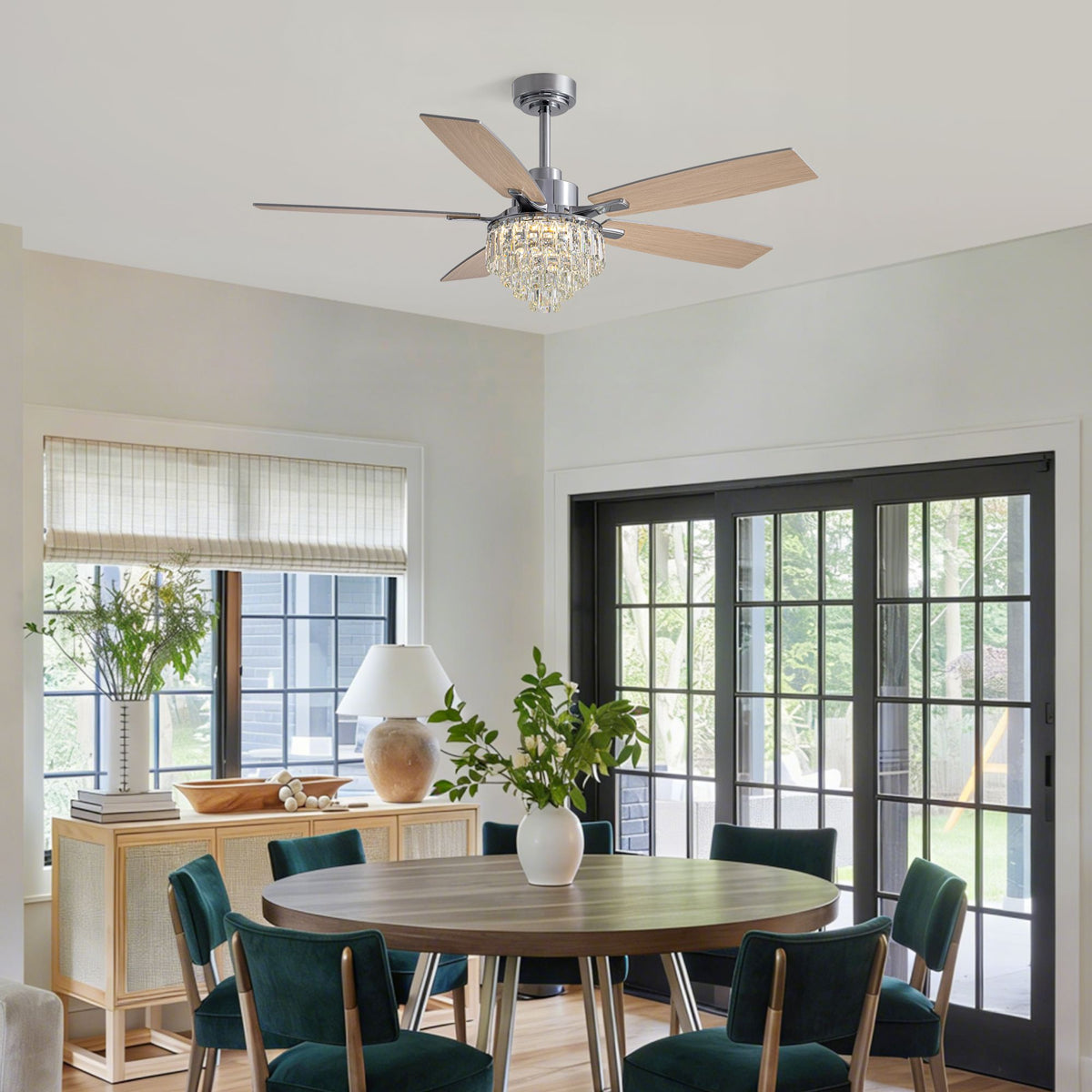 Modern dining room with chrome crystal fan — round wood table, green velvet chairs, glass doors, elegant dining space | Sofary Lighting