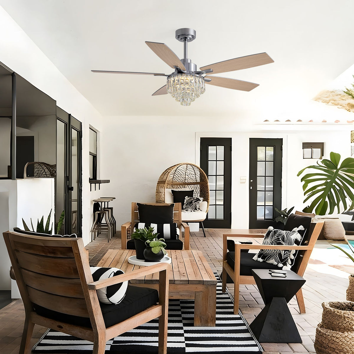 Crystal ceiling fan on outdoor patio — wooden furniture, black & white decor, tropical plants, stylish covered terrace | Sofary Lighting
