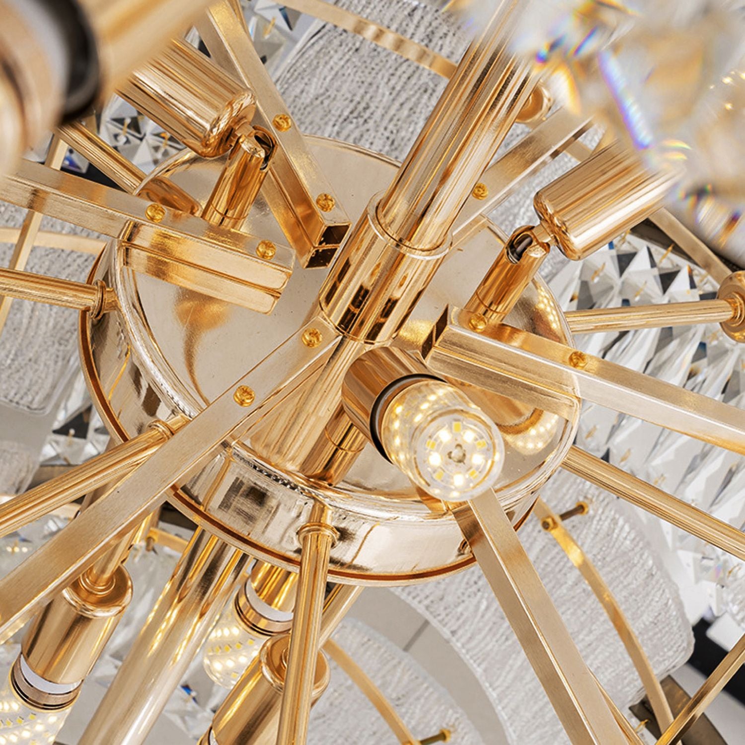 Aerioz chandelier top structure detail — gold electroplated arms, internal bulb sockets, radial framework, secure crystal mounting, premium metal craftsmanship | Sofary Lighting
