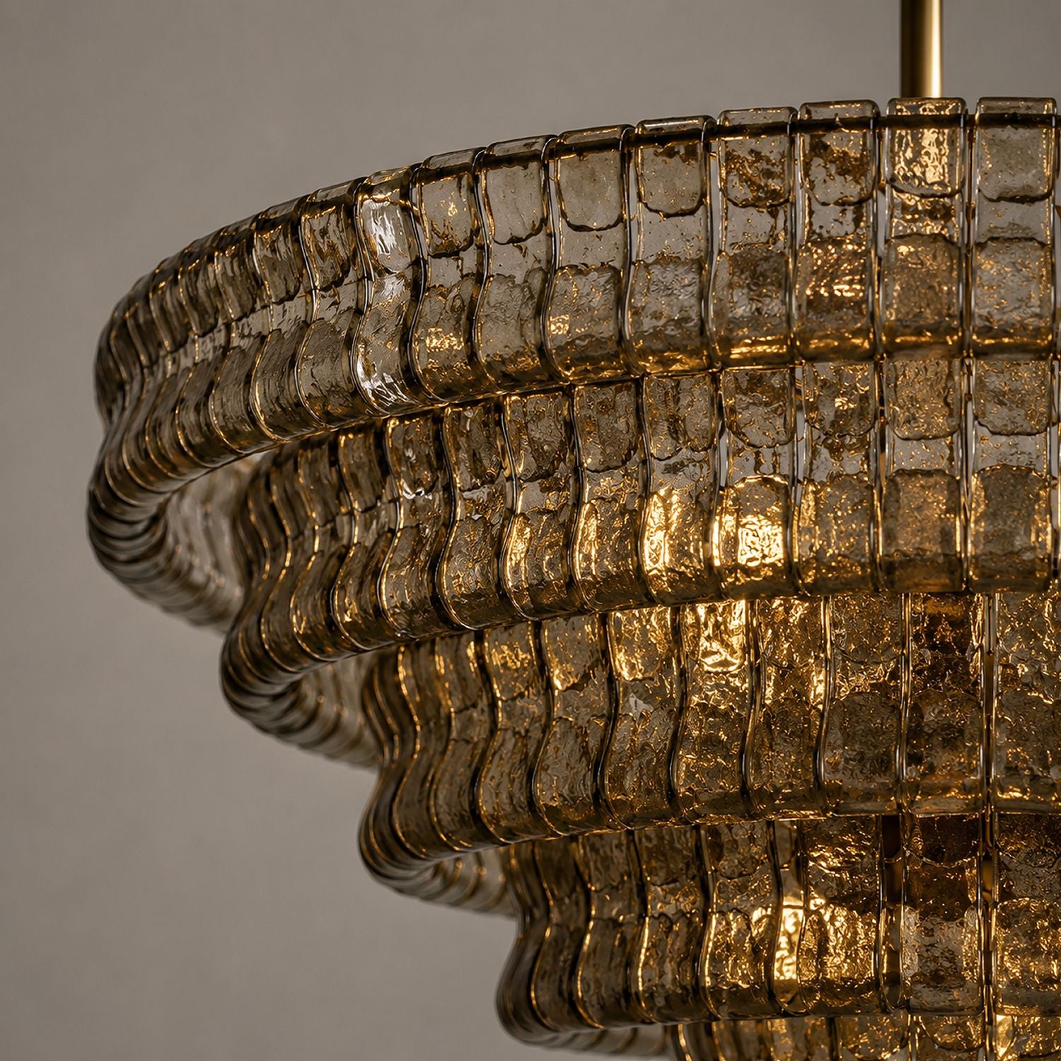Close-up of Aerore gold glass chandelier: handcrafted textured glass panels, brushed brass frame, intricate layering — showcasing premium materials and craftsmanship | Sofary Lighting