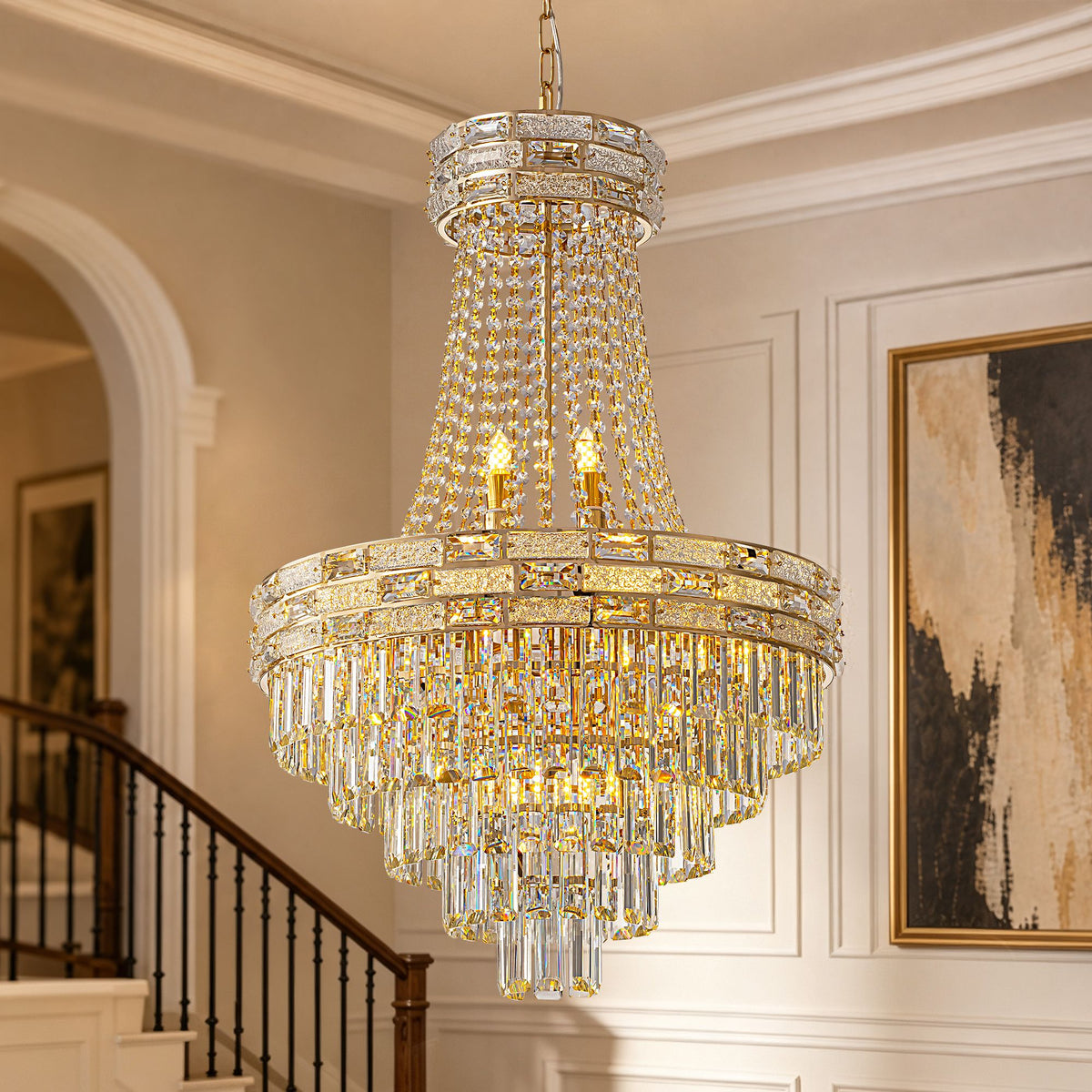 Aeros Empire Modern Gold Crystal Chandelier — tiered round gold frame, cascading clear K9 crystal beads and rectangular prisms, candle-style lights, staircase background, luxury pendant lighting | Sofary Lighting