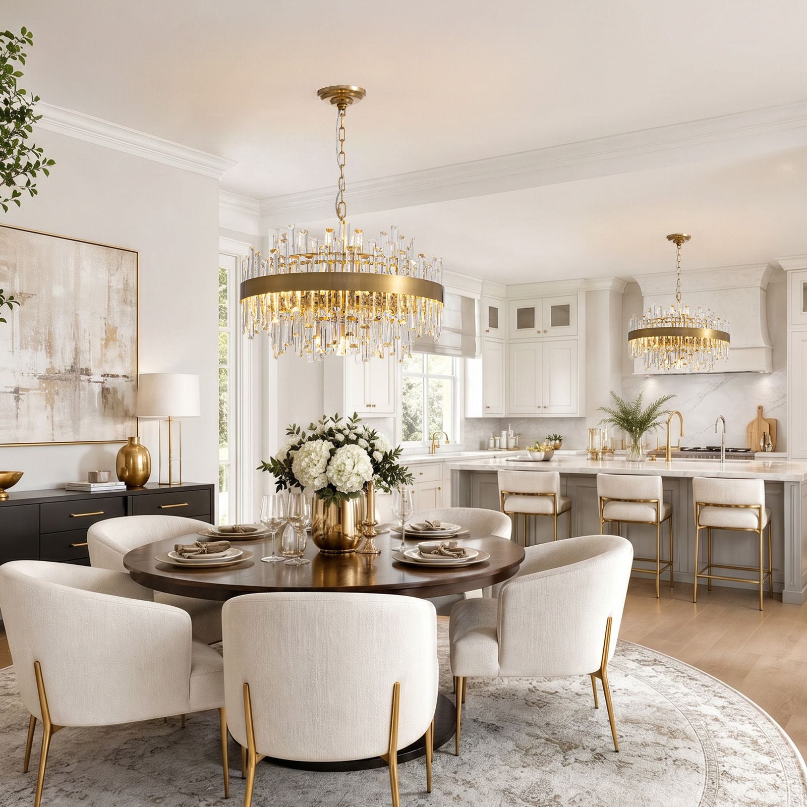 Aeroz Gold Crystal Chandelier over open kitchen island and dining area — white cabinetry, marble countertop, cream chairs, second matching fixture, bright airy space | Sofary Lighting