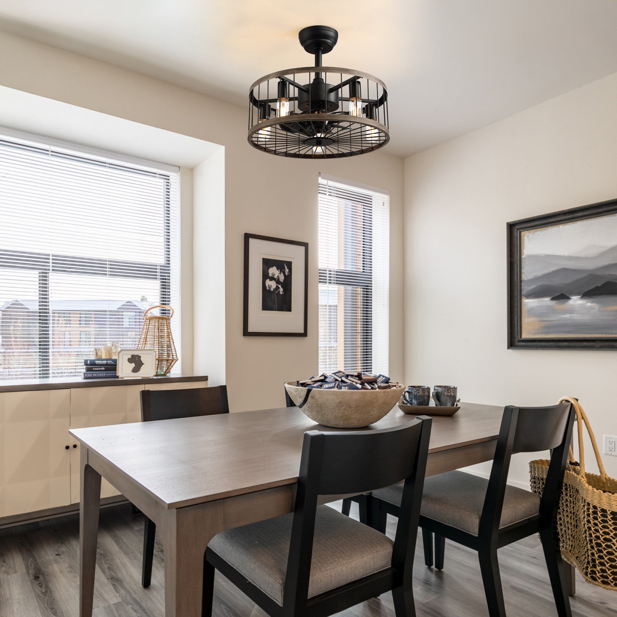 Aerozen drum caged fan in farmhouse dining room — wooden table, patterned chairs, black frame windows, warm Edison bulb glow, perfect for family meals | Sofary Lighting