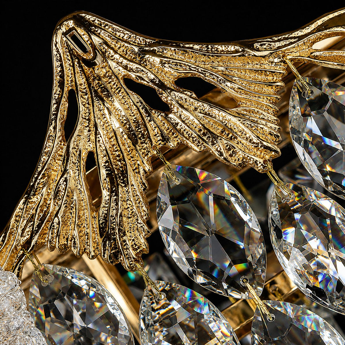 Close-up of Aerux Chandelier gold ornate metalwork and crystal pendants — leaf-vein filigree, teardrop and diamond K9 crystals, brilliant sparkle against dark background | Sofary Lighting