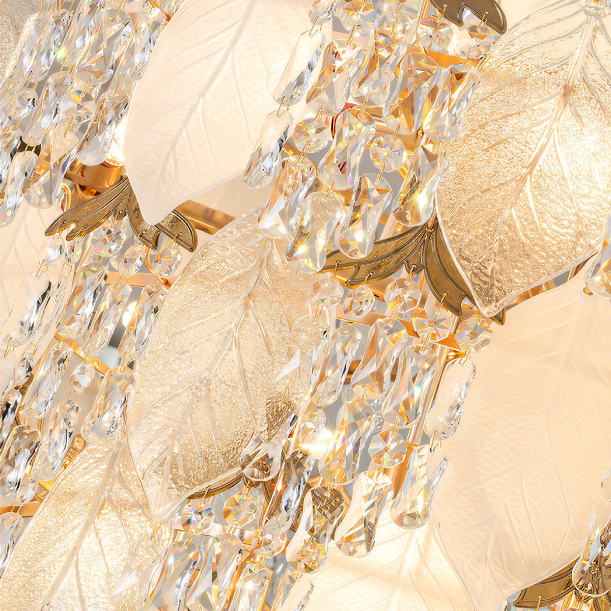 Close-up of Aevum chandelier — faceted K9 crystal drops, textured gold leaf-shaped elements, light refraction and iridescent sparkle, black background | Sofary Lighting
