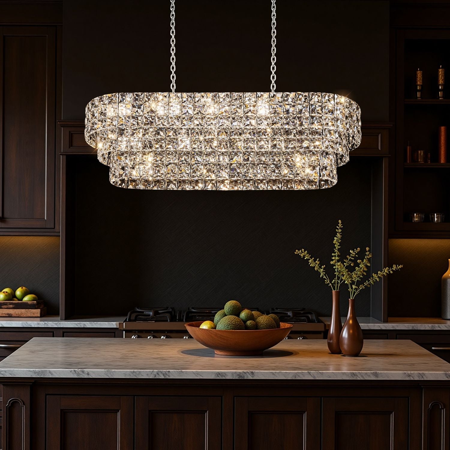 Aria Post-Modern Champagne Gold K9 Crystal Linear Three-Color Dimming Chandelier illuminates a kitchen island with a marble countertop, wooden bowl of fruits, and decorative vases, enhancing modern kitchen aesthetics | Sofary Lighting