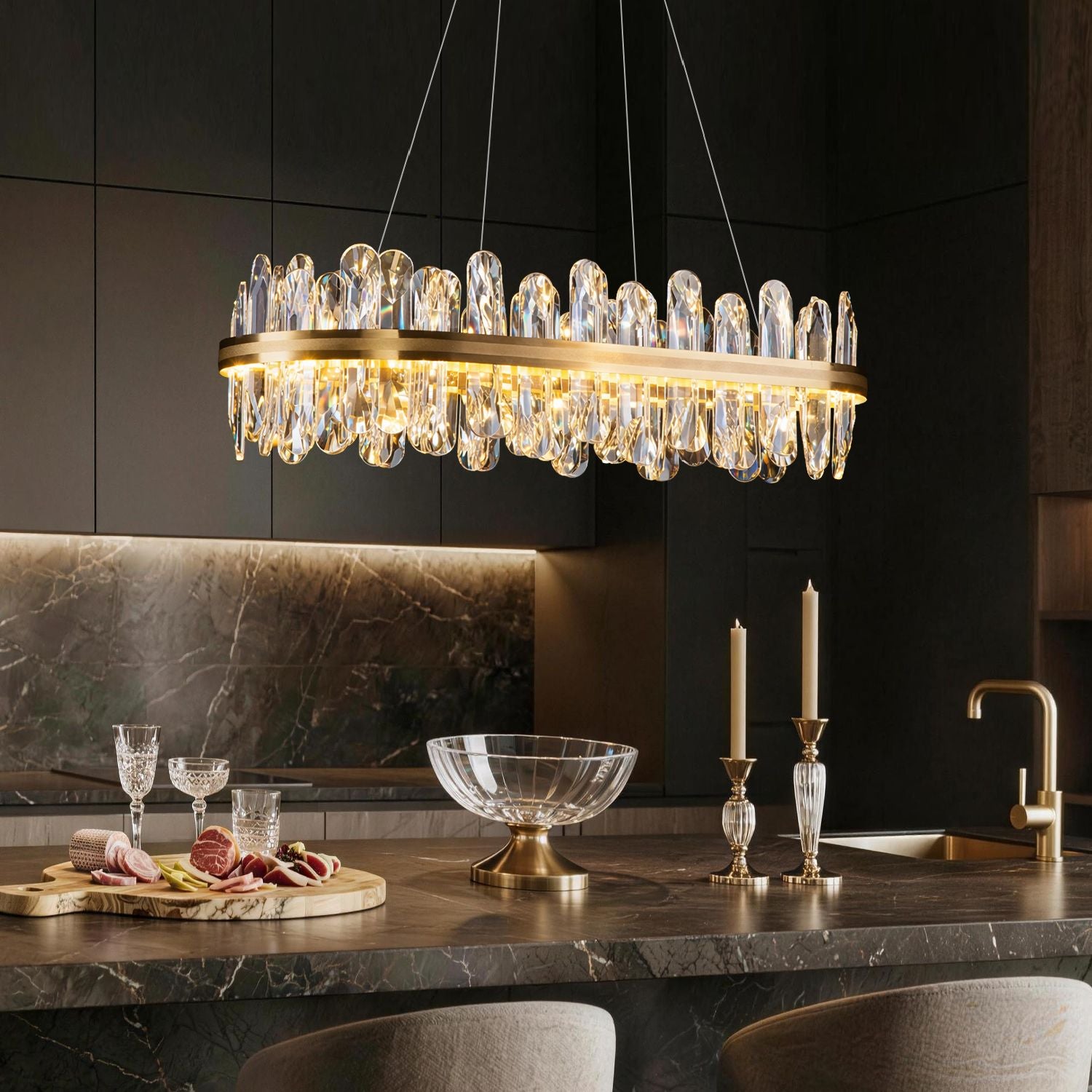 Aurelia Modern Luxury Champagne Gold Linear K9 Crystal LED Chandelier in a kitchen island — above a marble countertop with candles, a glass bowl, and dark cabinets | Sofary Lighting