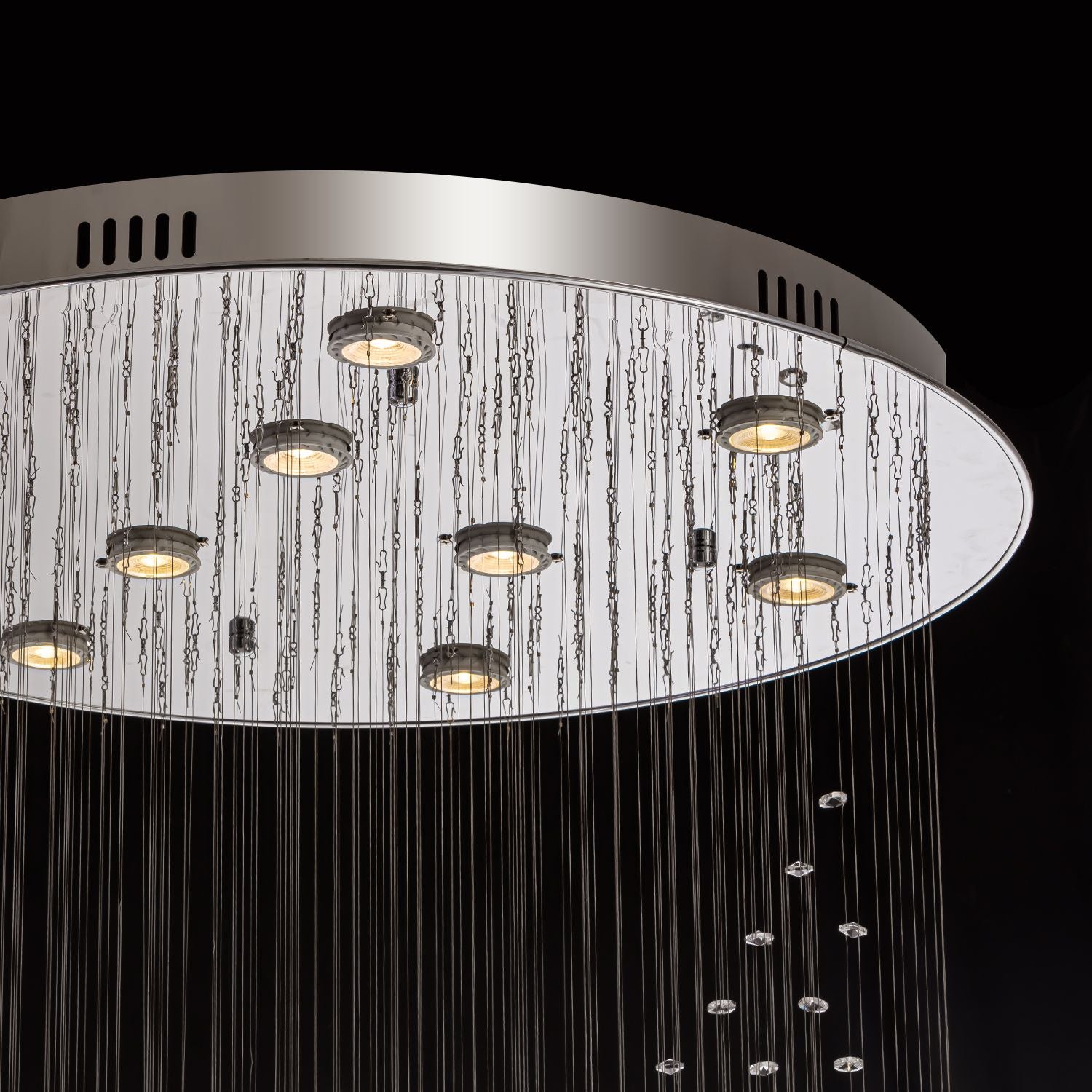 Close-up of modern spiral crystal chandelier showing three sphere raindrop design details | Sofary
