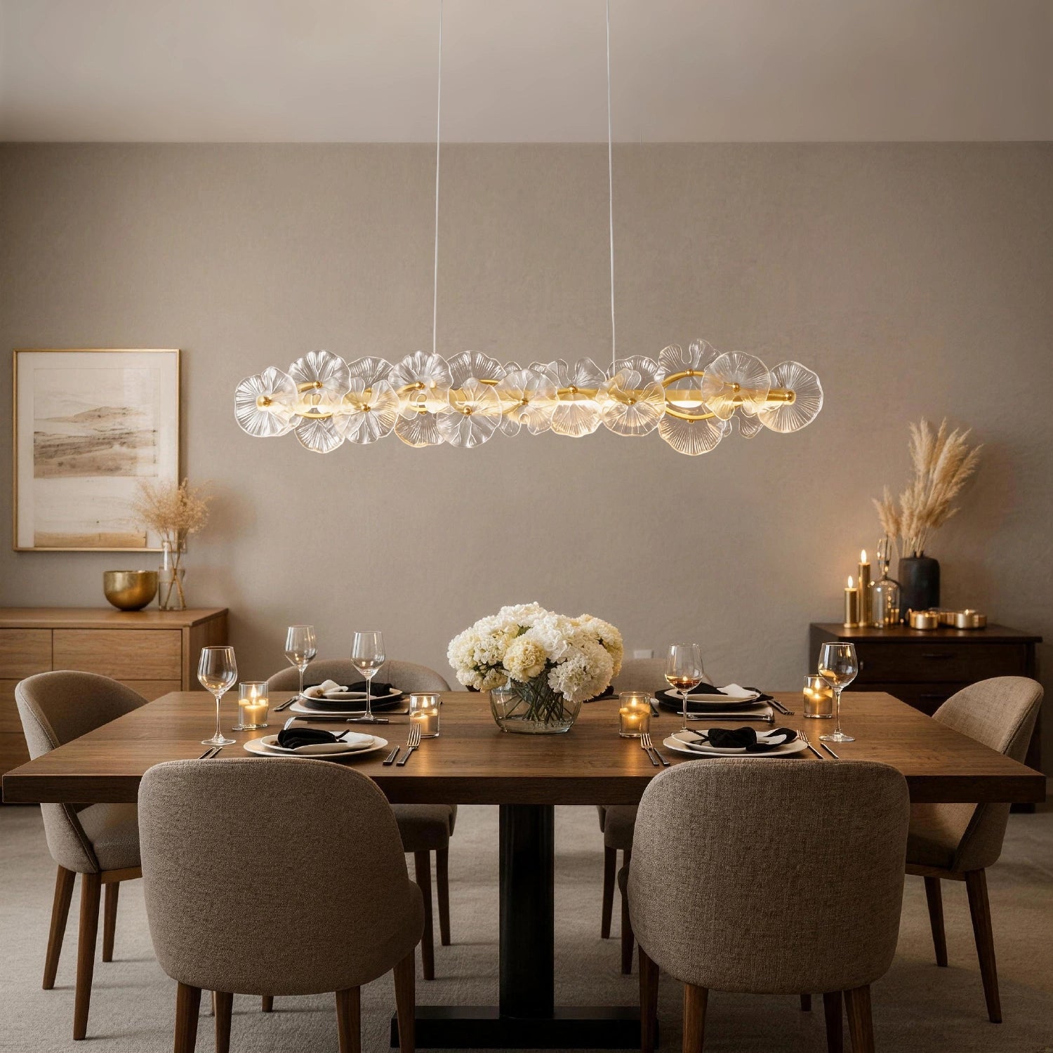 Elegant Contemporary Linear Glass Flower Chandelier providing warm ambient lighting for a formal dining table set with candles and glassware.Sofary Lighting