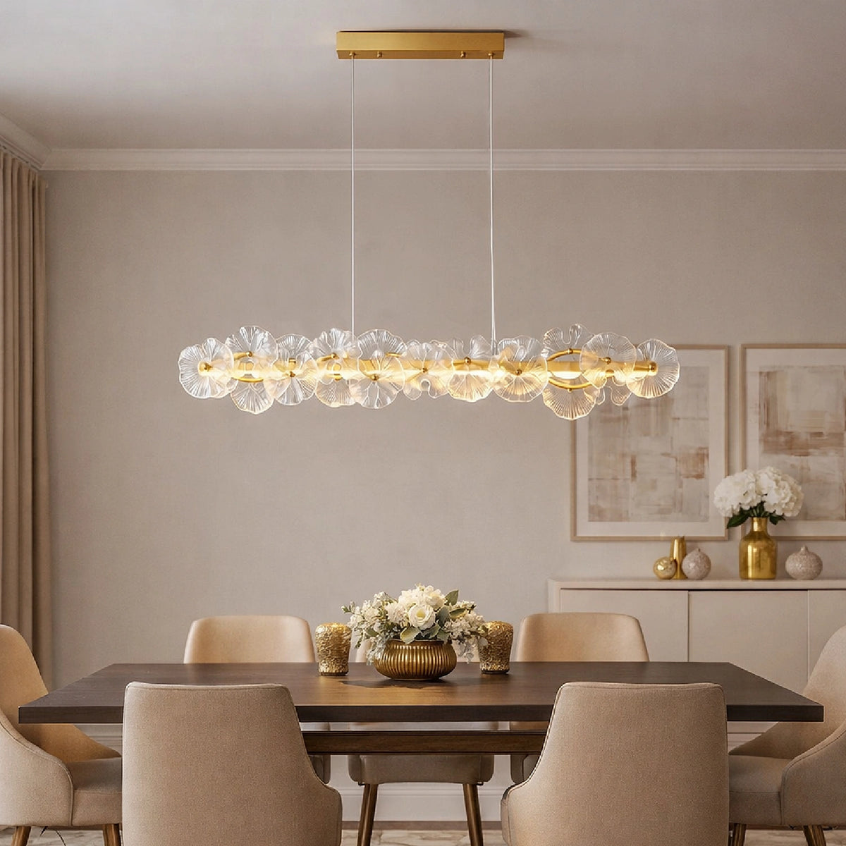 A long Contemporary Linear Glass Flower Chandelier illuminating a modern dining area with a dark wood table and beige upholstered chairs. Sofary Lighting
