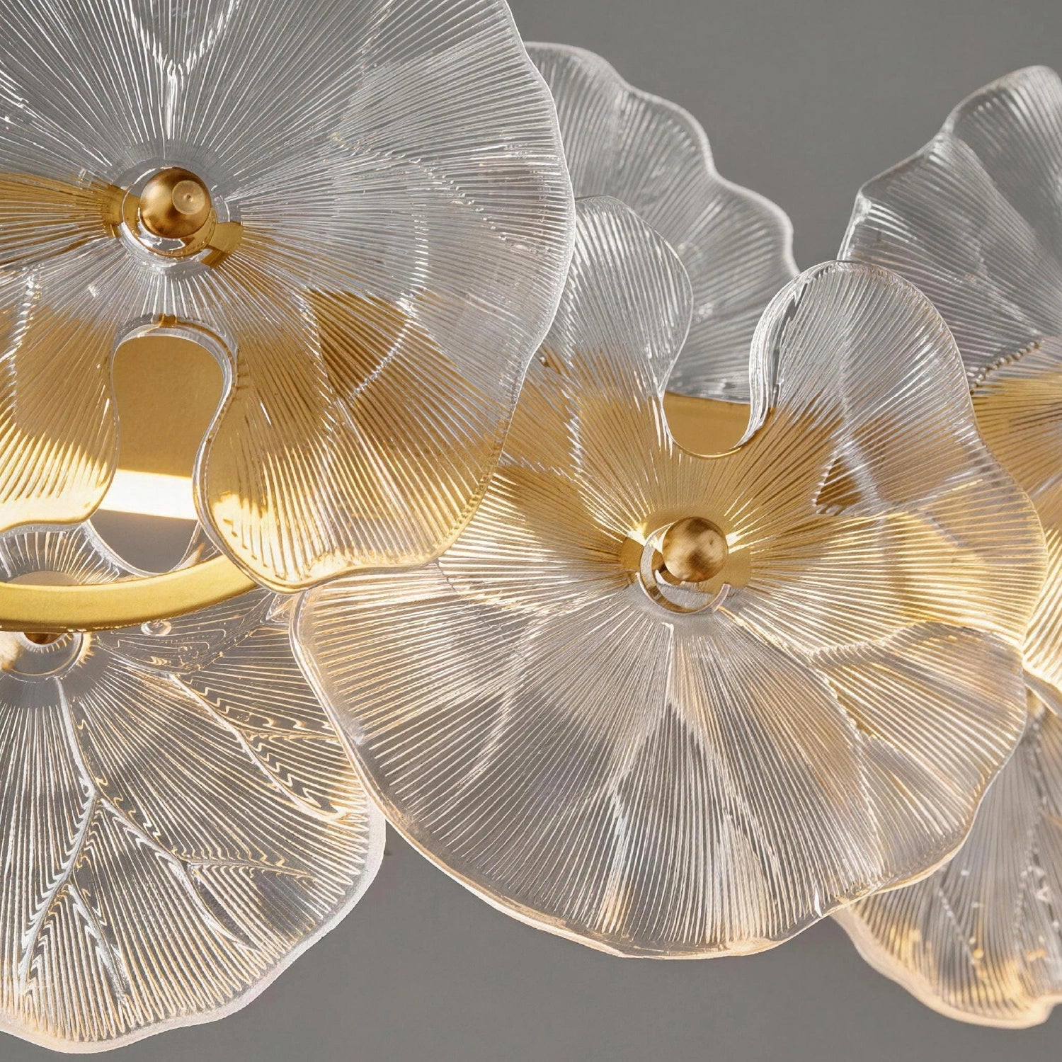 Macro view of the Contemporary Linear Glass Flower Chandelier frame, highlighting the premium brushed gold finish and metal craftsmanship. Sofary Lighting