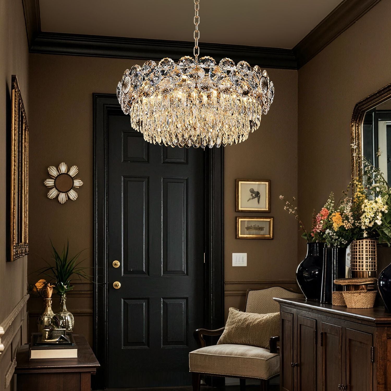 Glacia Modern Luxury Staggered K9 Crystal Flush Mount Chandelier in a foyer — hanging above a black double door with gold accents, next to a console table with flowers and candles | Sofary Lighting