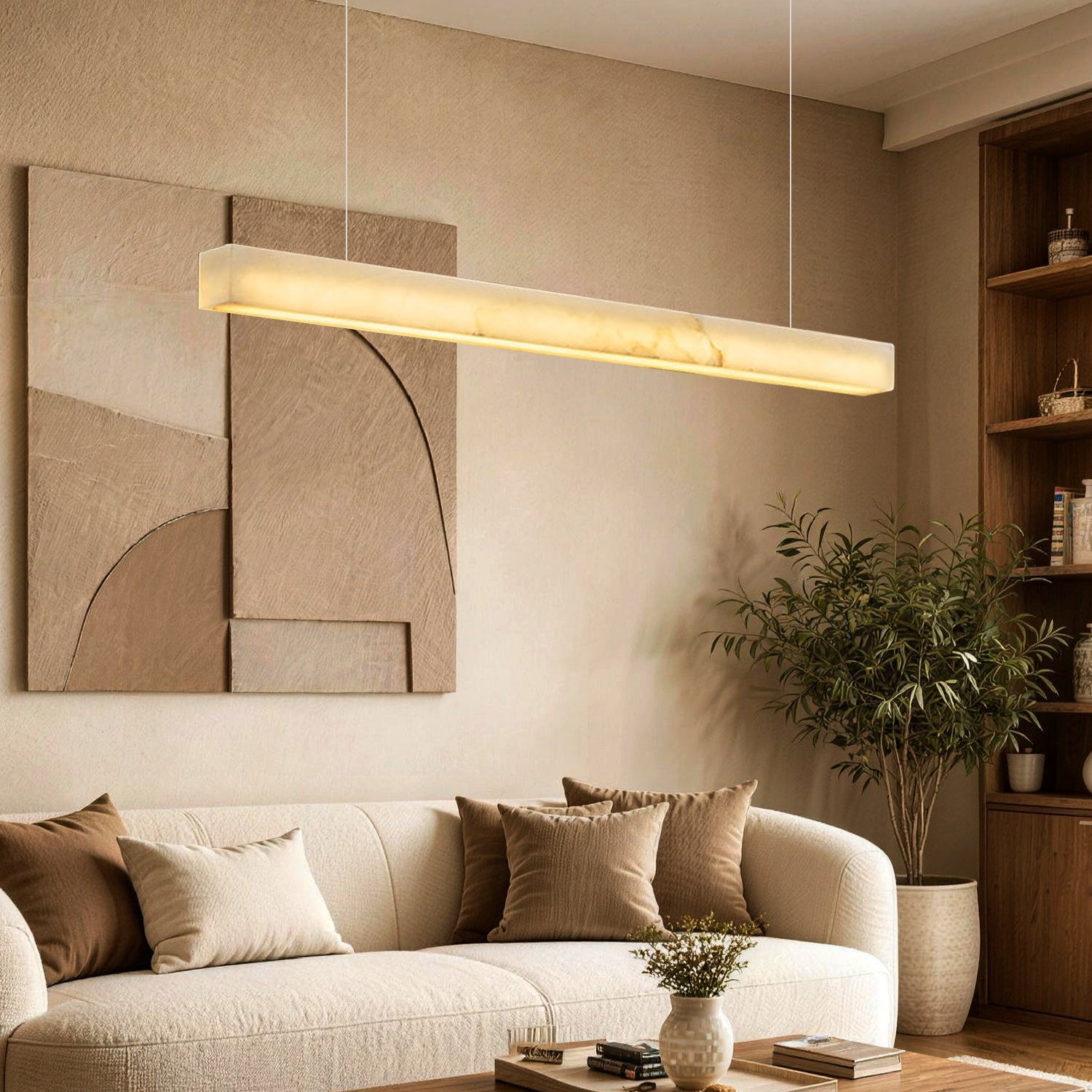Horizon Modern Minimalist Alabaster Ultra-Slim Linear LED Chandelier in a living room — illuminating a beige sectional sofa with earth-toned pillows, a dark wood coffee table, and abstract wall art | Sofary Lighting