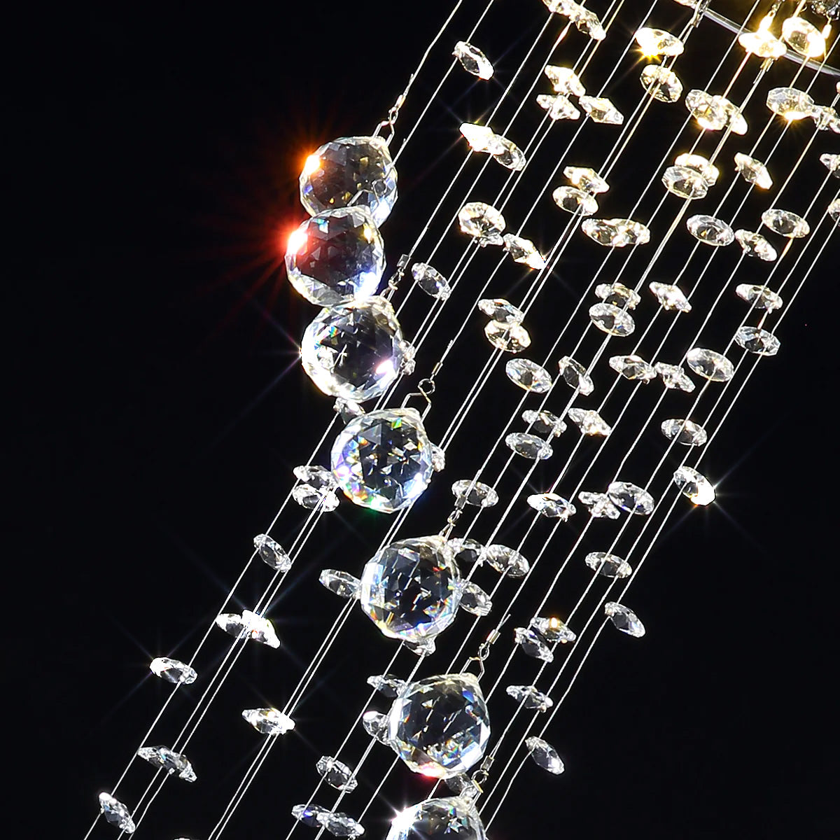 close up detail of k9 crystal raindrop elements used in spiral staircase chandelier lighting | Sofary Lighting