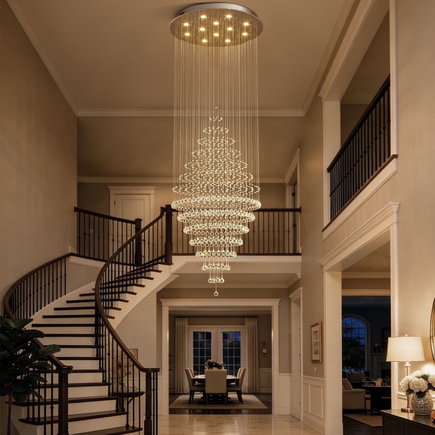 modern round crystal chandelier staircase lighting fixture hanging above curved staircase in luxury home | Sofary Lighting