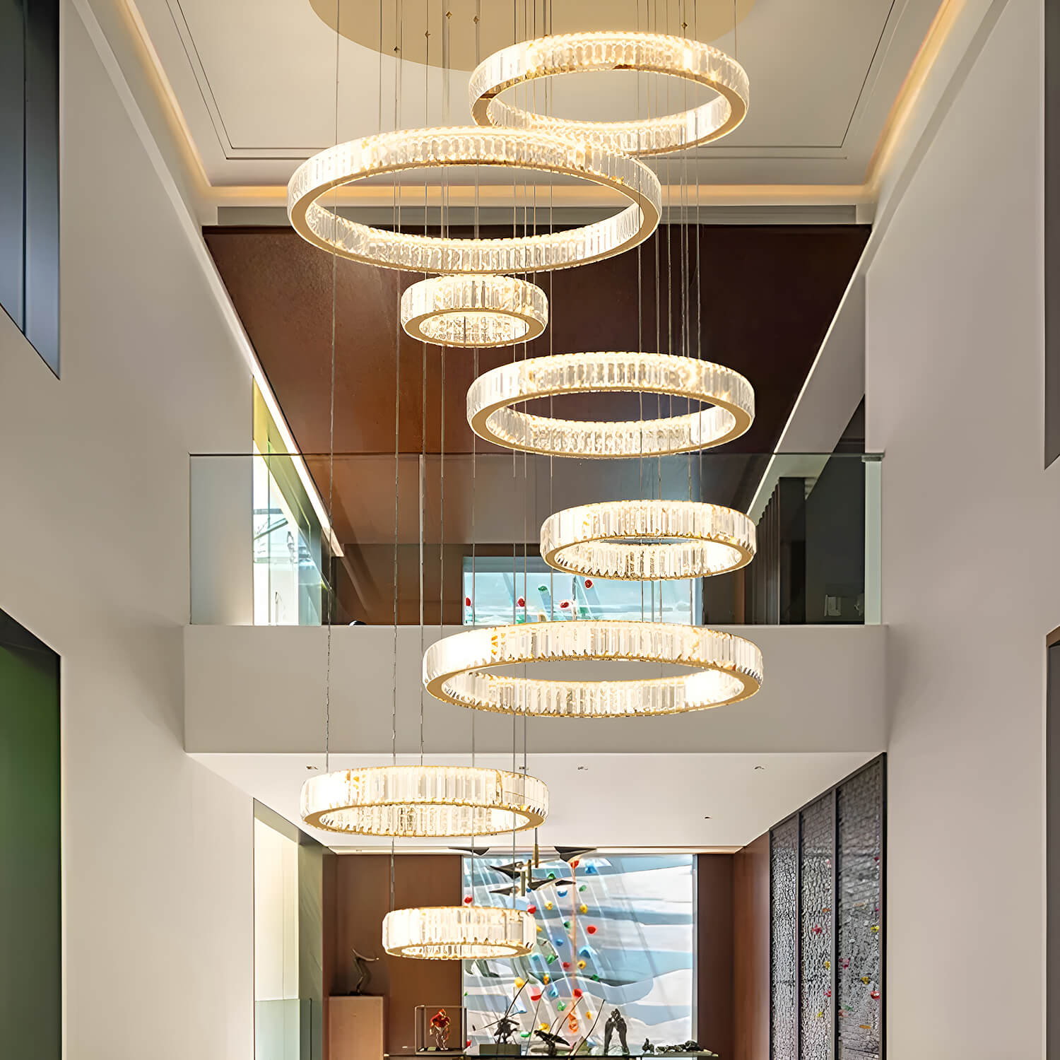 luxury oversized round gold crystal chandelier lighting installed in modern high ceiling foyer | Sofary Lighting