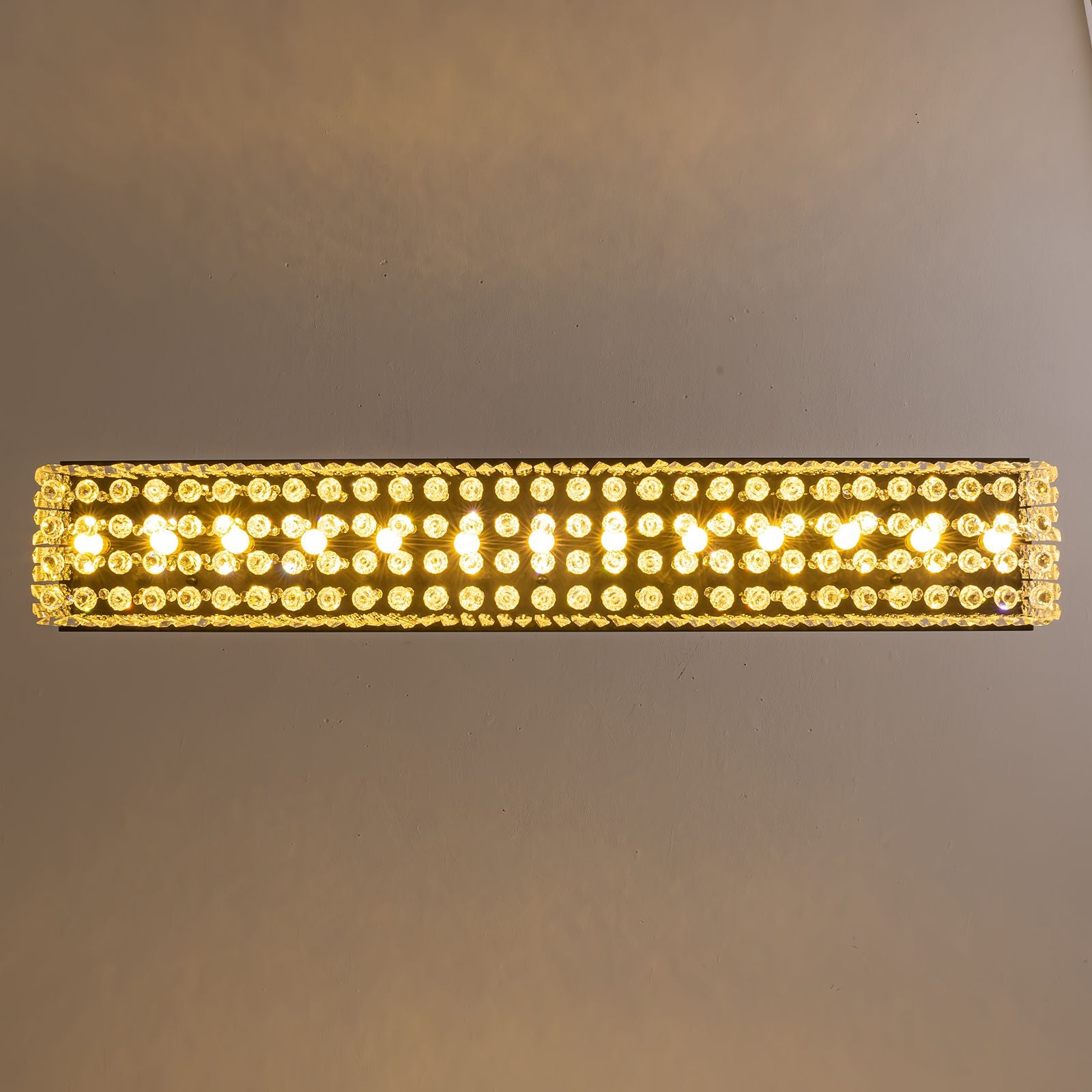 Close-up of Matrix Linear Chandelier — dense array of faceted crystal prisms, warm LED glow, and sleek black metal frame, highlighting premium craftsmanship and light refraction | Sofary Lighting