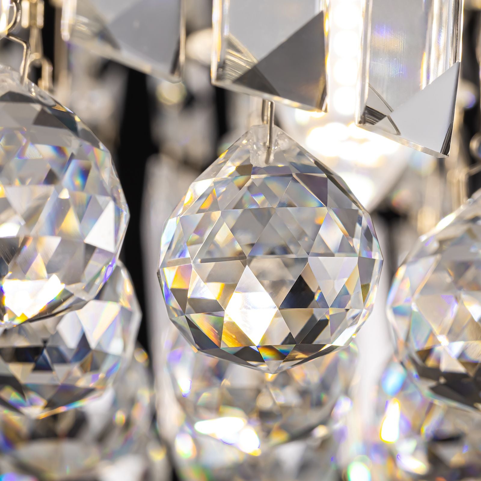 Close-up of Matrix Chandelier crystal prisms — faceted geometry, light refraction, and precision mounting on black metal frame | Sofary Lighting