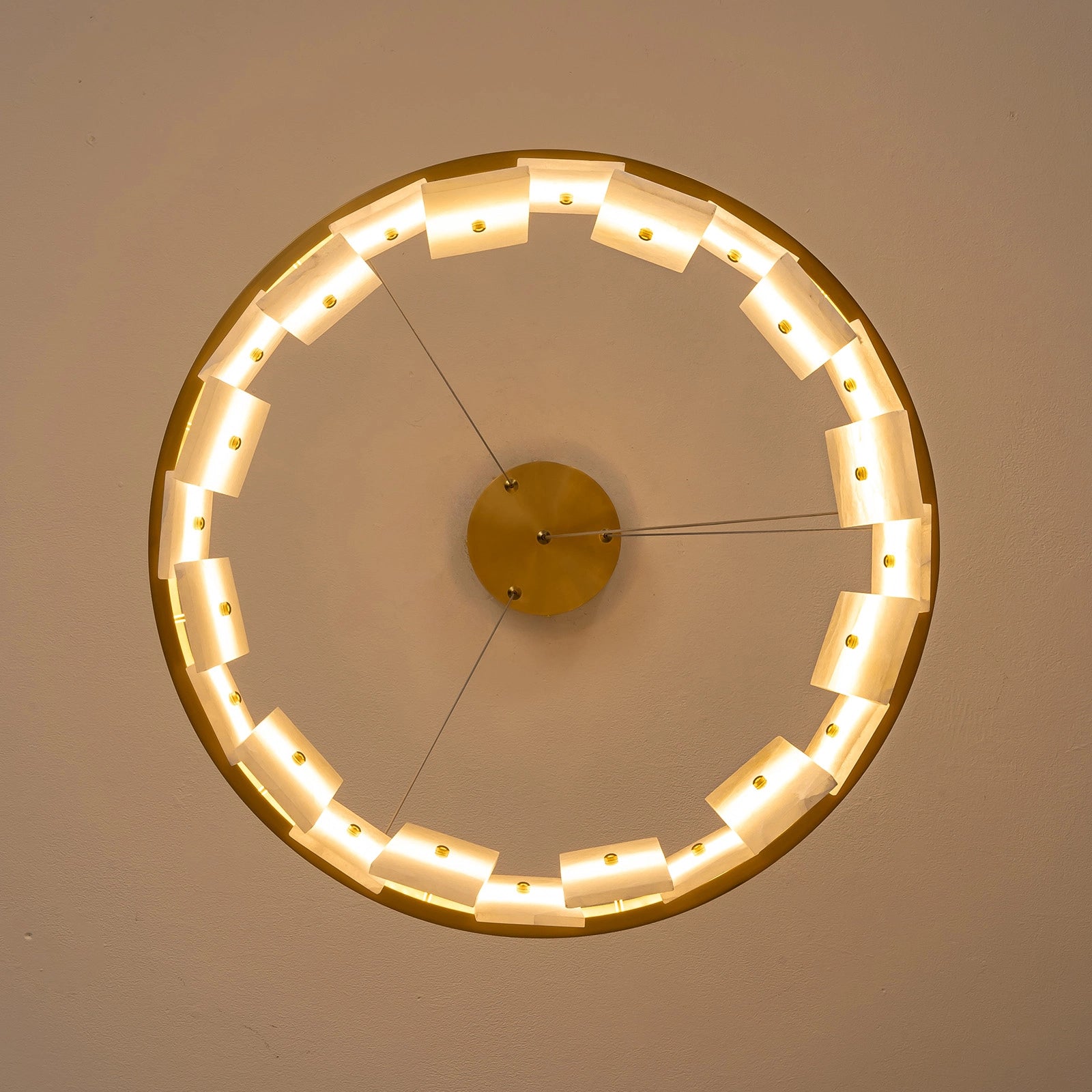 underside-view-modern-round-alabaster-gold-chandelier-with-circular-gold-frame-and-evenly-spaced-alabaster-panels-emitting-warm-light-sofary-lighting