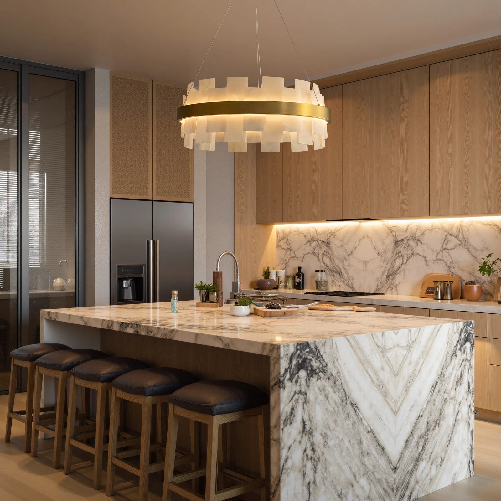 modern-round-alabaster-gold-chandelier-with-layered-alabaster-panels-and-central-gold-band-hanging-above-marble-kitchen-island-with-warm-ambient-light-sofary-lighting