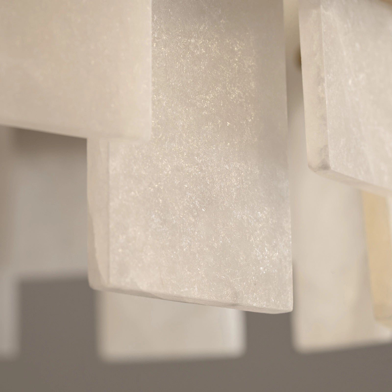 close-up-of-modern-round-alabaster-gold-chandelier-with-circular-gold-frame-and-evenly-spaced-alabaster-panels-emitting-warm-light-sofary-lighting