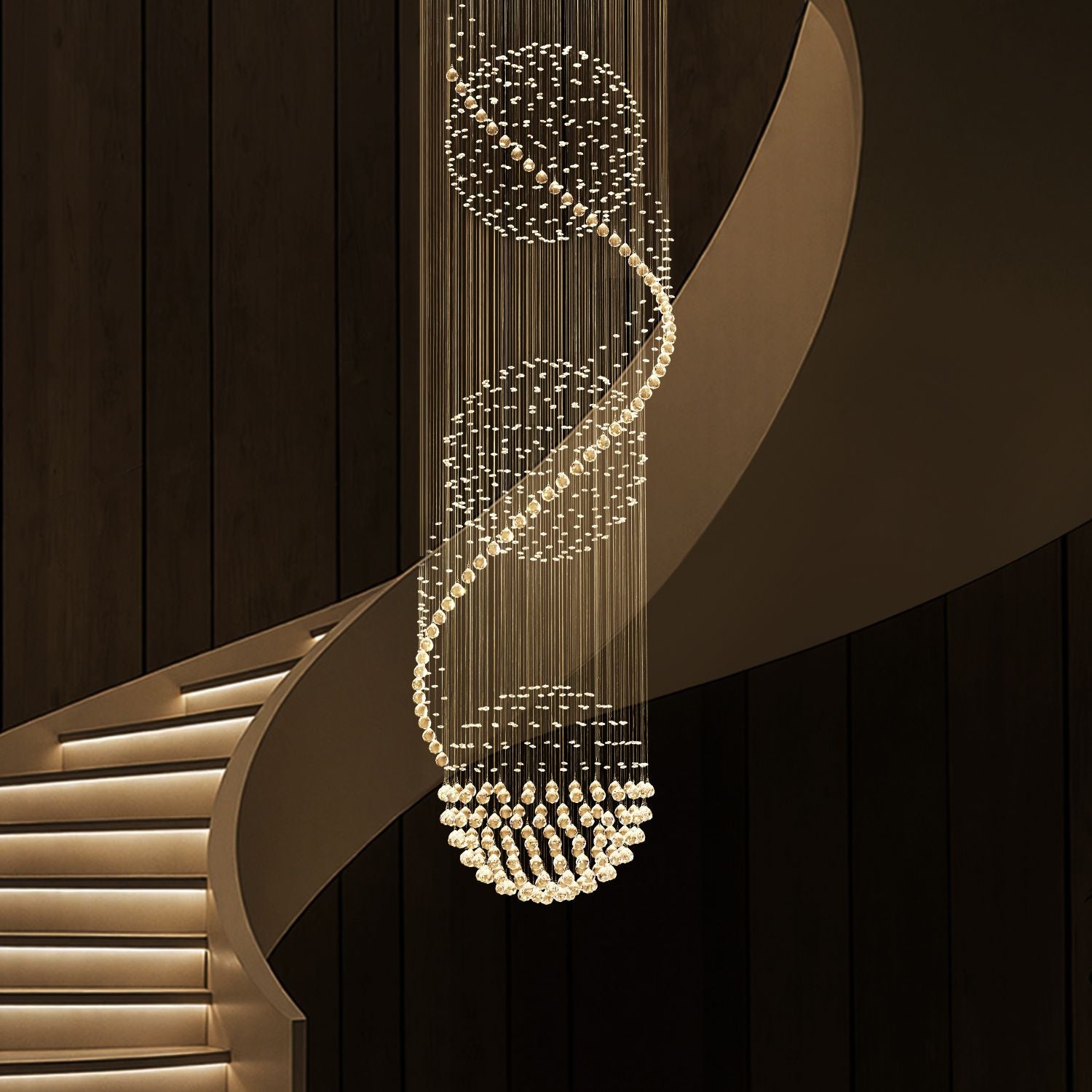 modern spiral three sphere raindrop crystal chandelier lighting hanging over curved staircase in luxury interior | Sofary