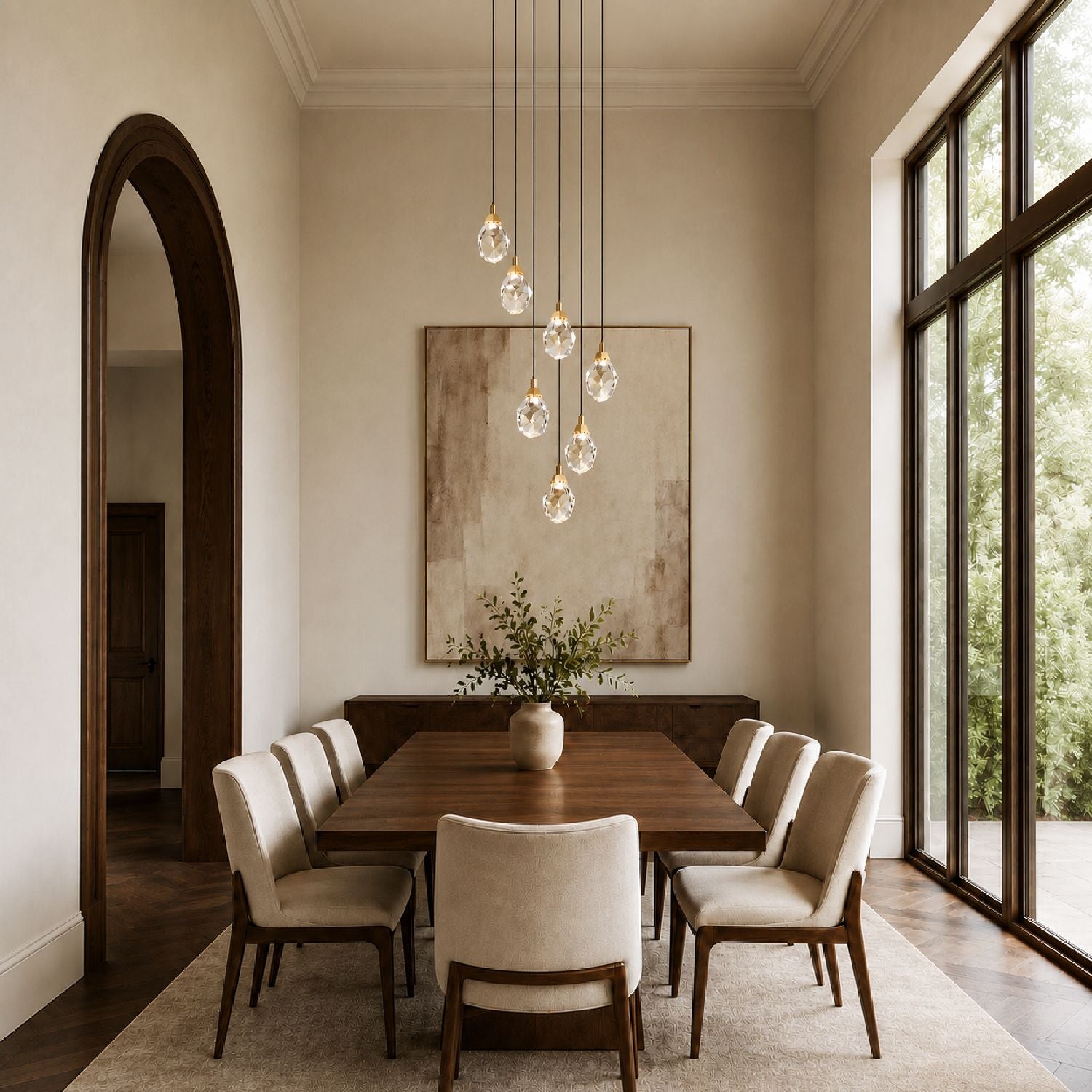 Nirvana Chandelier above a rustic dining table — beige upholstered chairs, textured rug, large landscape artwork, and warm golden illumination for intimate meals | Sofary Lighting