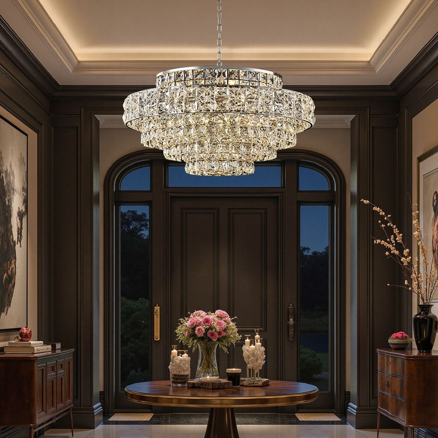 Valeria Luxury Chrome K9 Crystal Wave Chandelier in a foyer — illuminating a round entryway table with a vase of pink roses, candles, and antique decor against dark paneled walls | Sofary Lighting