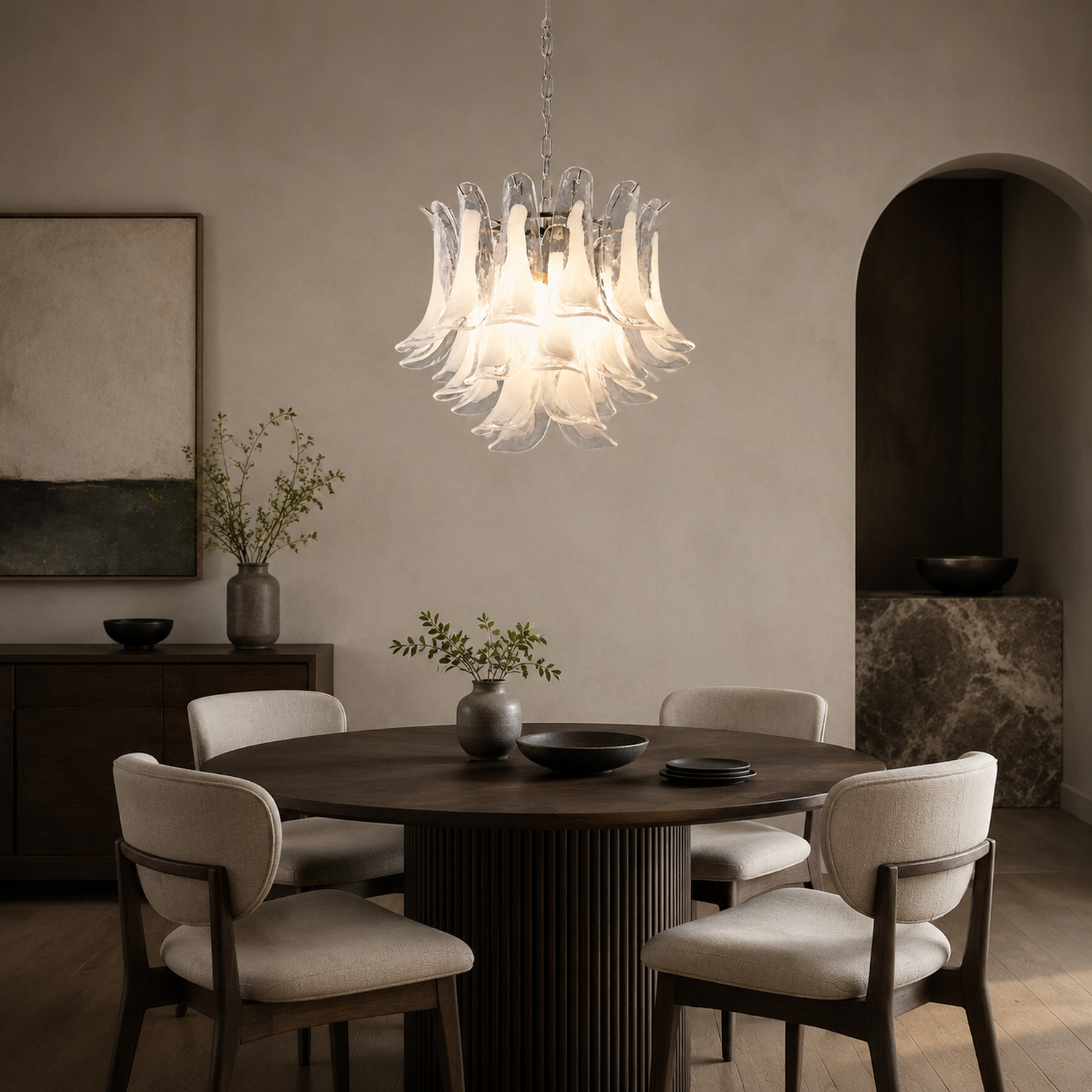 Veloria round glass petal chandelier above a dining table