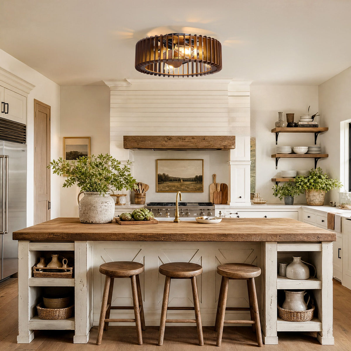 Industrial caged ceiling fan over farmhouse kitchen island — wood countertop, black stools, white shiplap walls, open shelving with dishes and plants, pendant warm light | Sofary Lighting