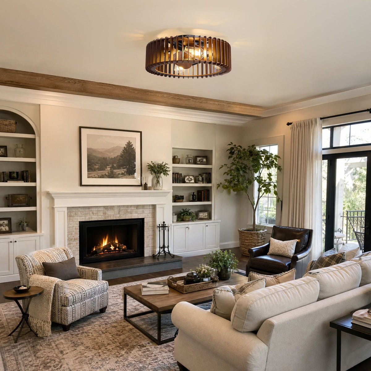 Industrial caged ceiling fan in farmhouse living room — beige sofa, patterned armchair, dark leather chair, lit fireplace, bookshelves, wood beam ceiling, vintage rug | Sofary Lighting