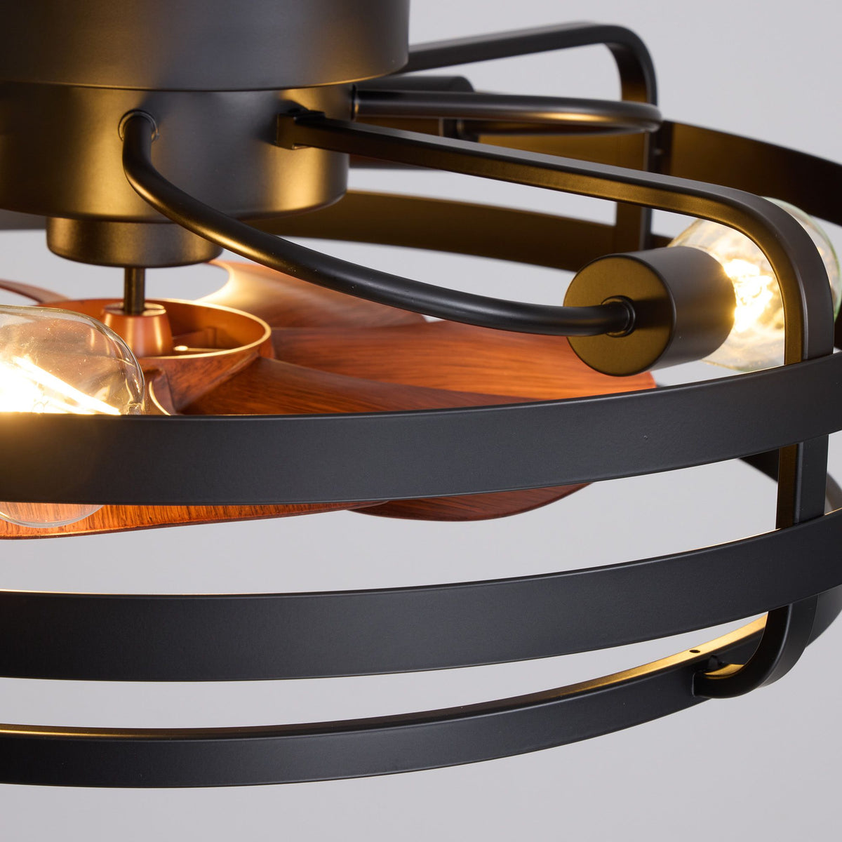 Ceiling fan motor and cage structure — gold motor housing, black metal cage bands, wood blades, exposed bulbs, sturdy construction | Sofary Lighting