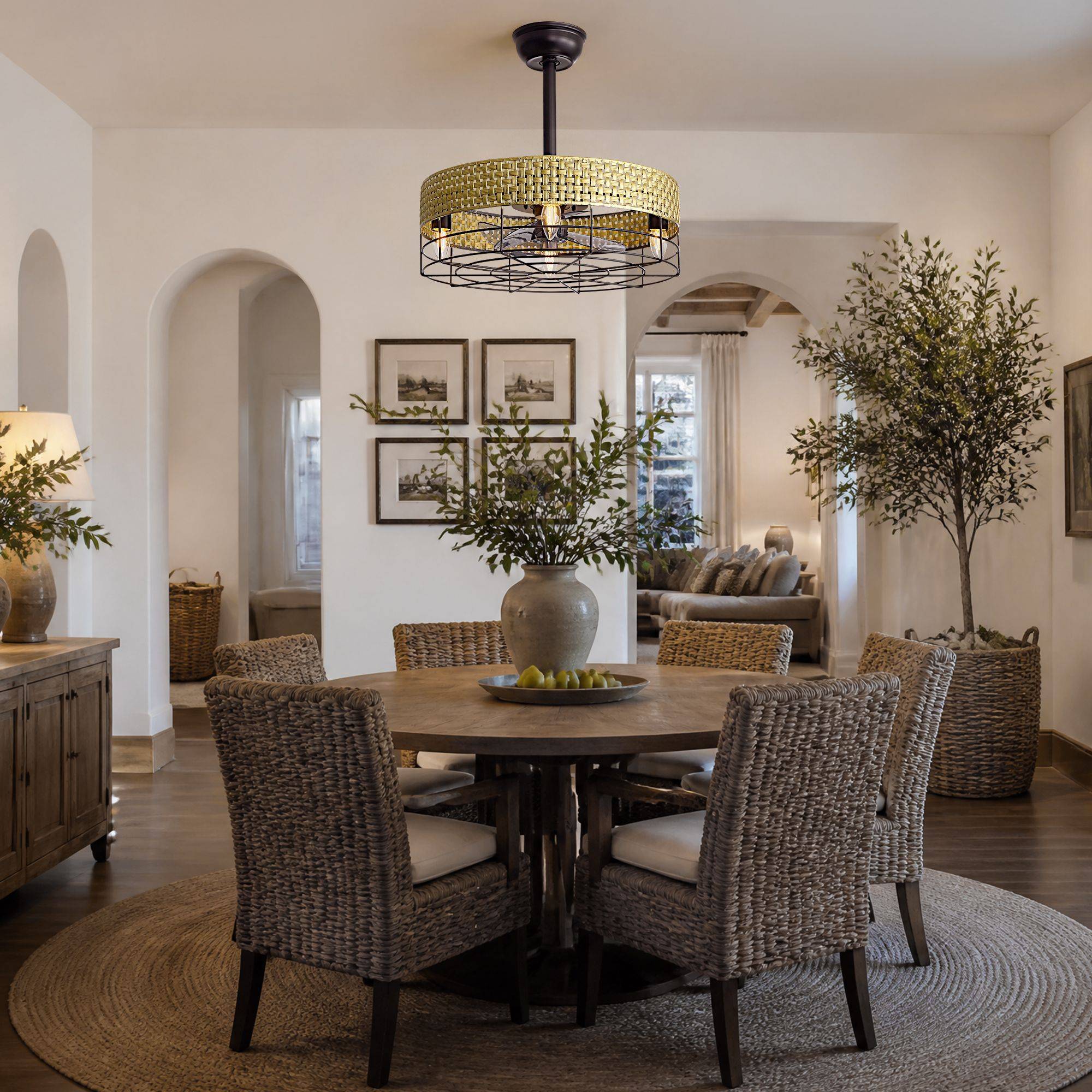 Rattan caged fan in dining room — round wood table, woven chairs, arched entryways, olive tree, neutral boho interior | Sofary Lighting