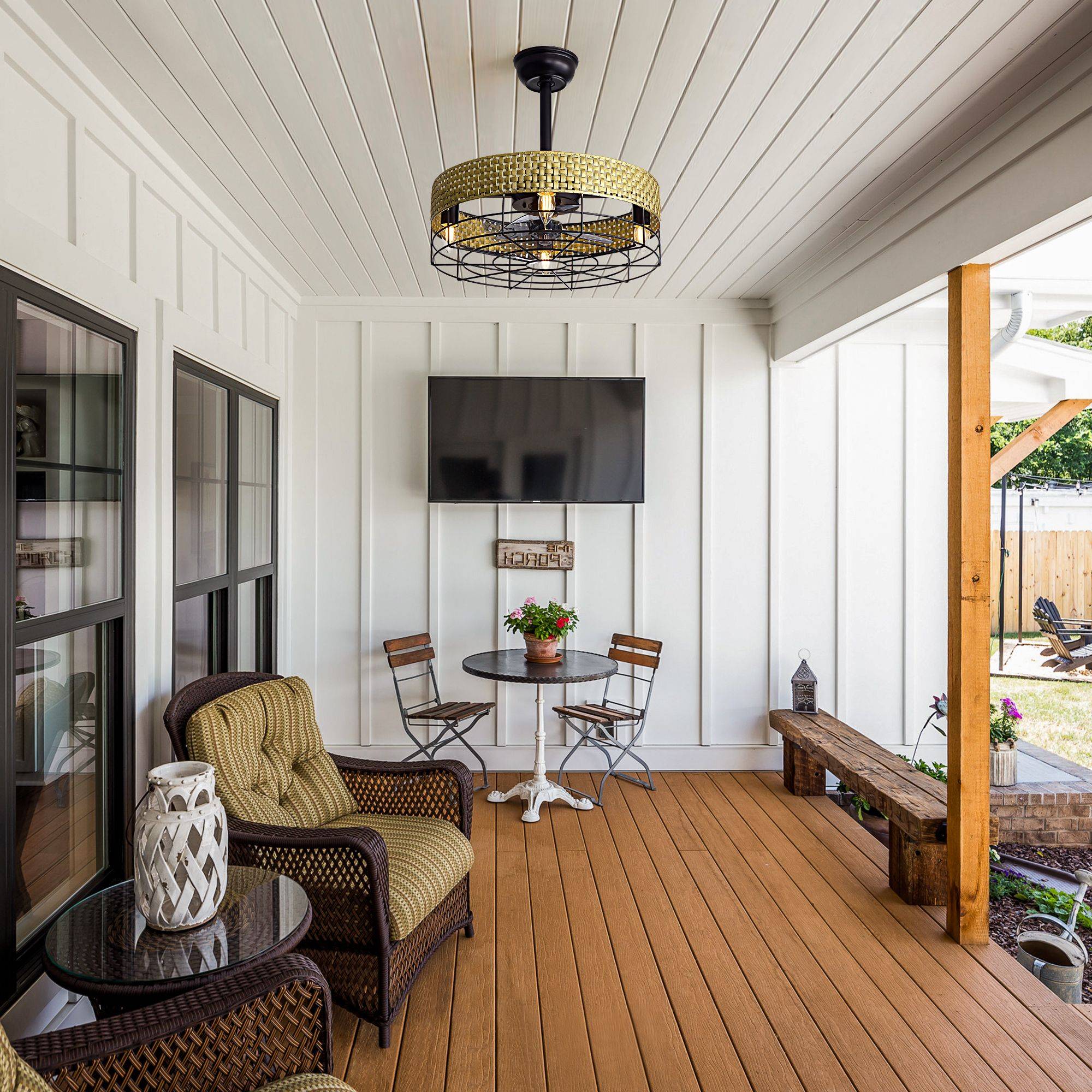 Outdoor patio ceiling fan with rattan cage — covered porch, wood deck, wicker seating, wall TV, outdoor living space | Sofary Lighting