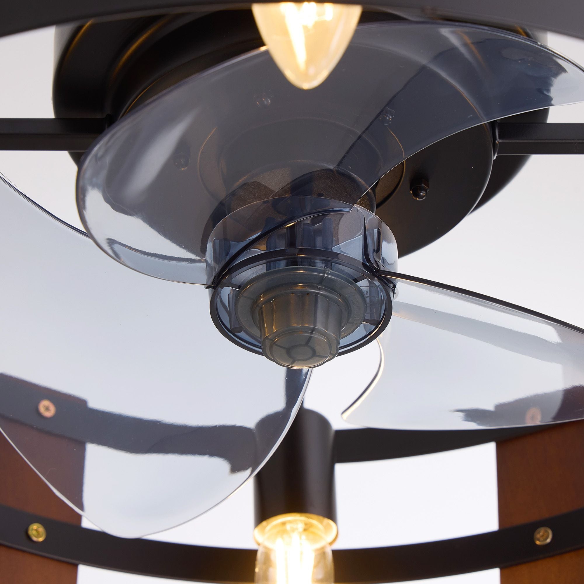 Close-up of enclosed fan blades and motor — translucent blades, glossy black motor hub, caged ceiling fan detail | Sofary Lighting