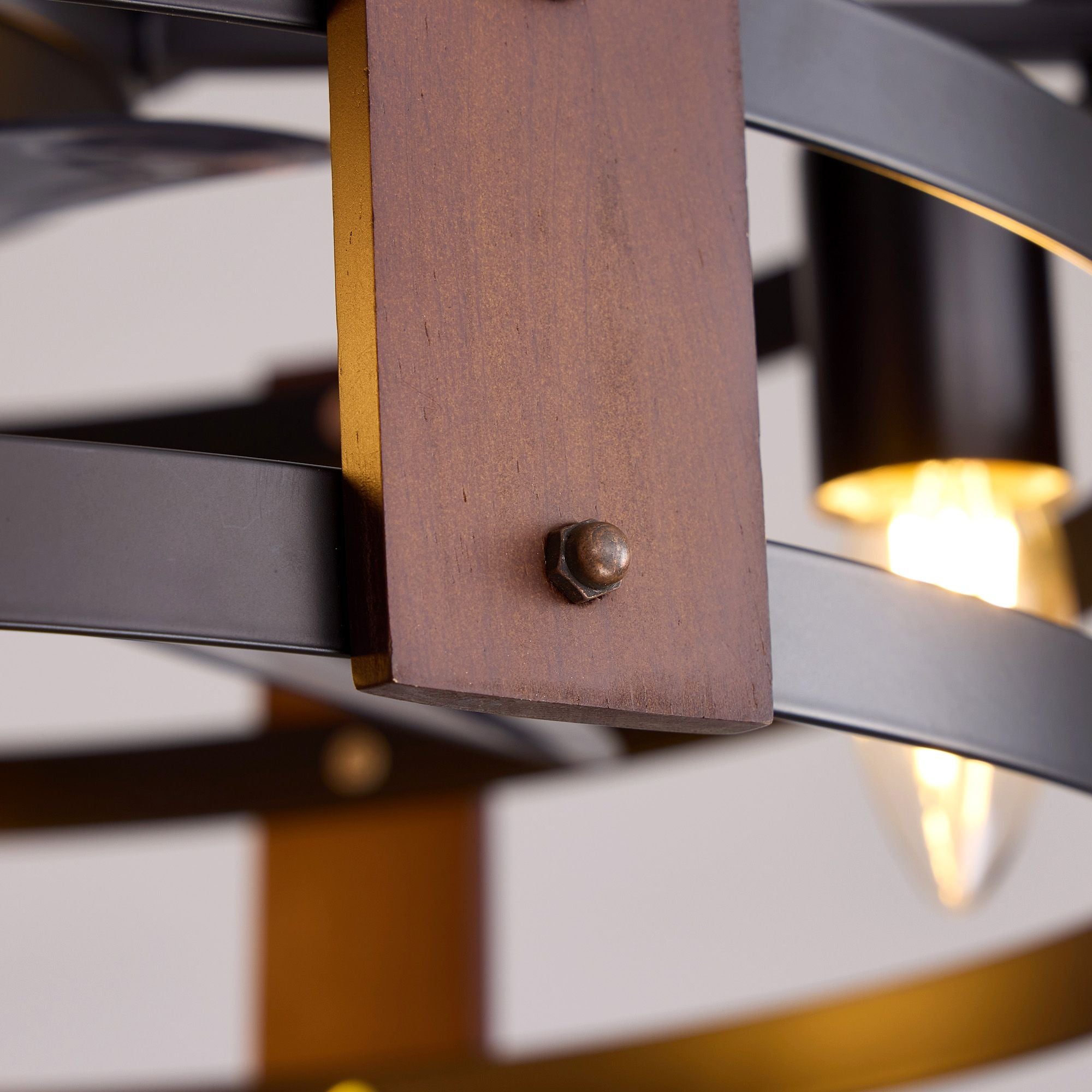 Close-up of rustic wood accent and metal rivet — premium wood grain panel, matte black frame, vintage industrial craftsmanship, warm bulb bokeh | Sofary Lighting
