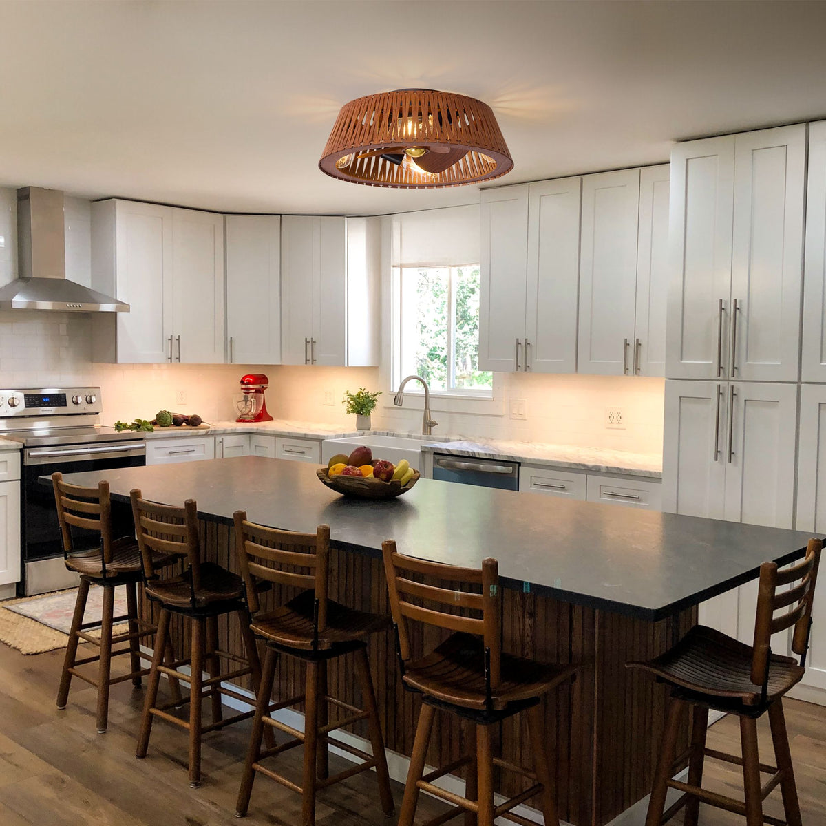 Caged brown ceiling fan over kitchen island — white cabinetry, wooden stools, warm light, modern farmhouse kitchen decor | Sofary Lighting