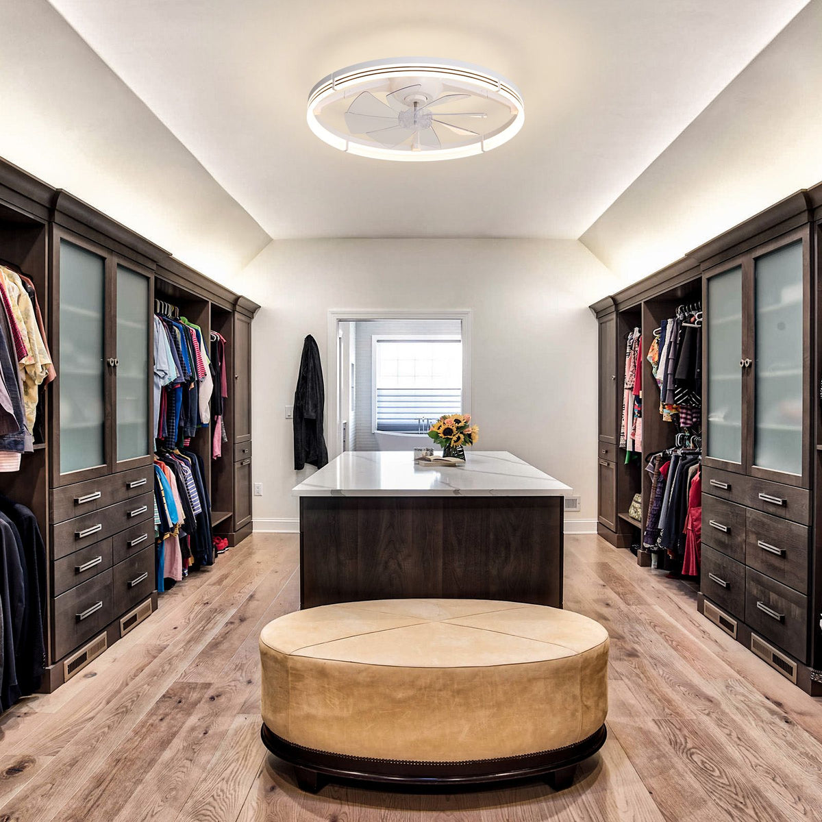 White foldable ceiling fan in luxury walk-in closet — dark wood cabinetry, frosted glass doors, white island with flowers, round ottoman, flush ceiling fan | Sofary Lighting