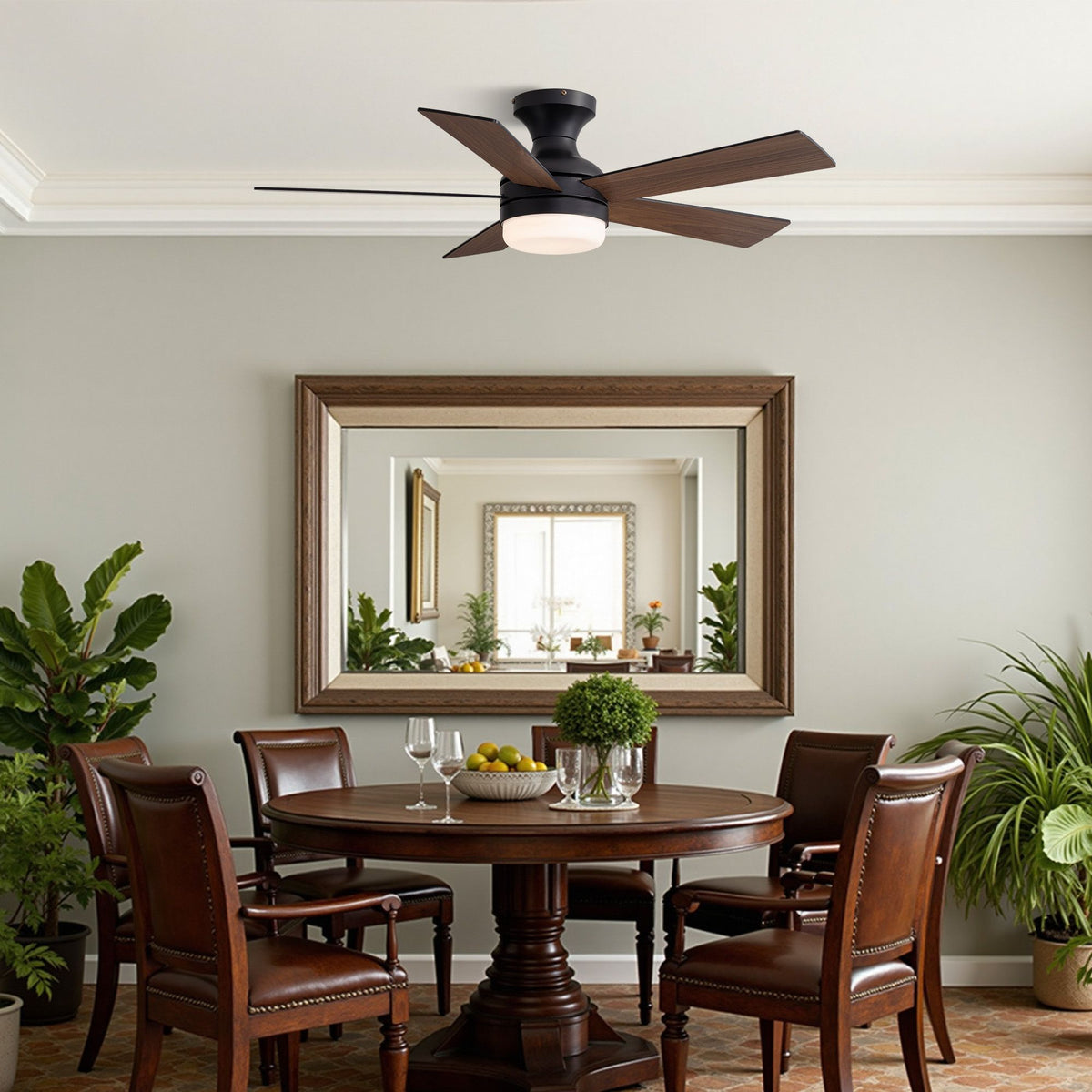 Black ceiling fan in traditional dining room — dark wood round table, leather chairs, large wall mirror, green plants, warm LED glow, farmhouse decor | Sofary Lighting