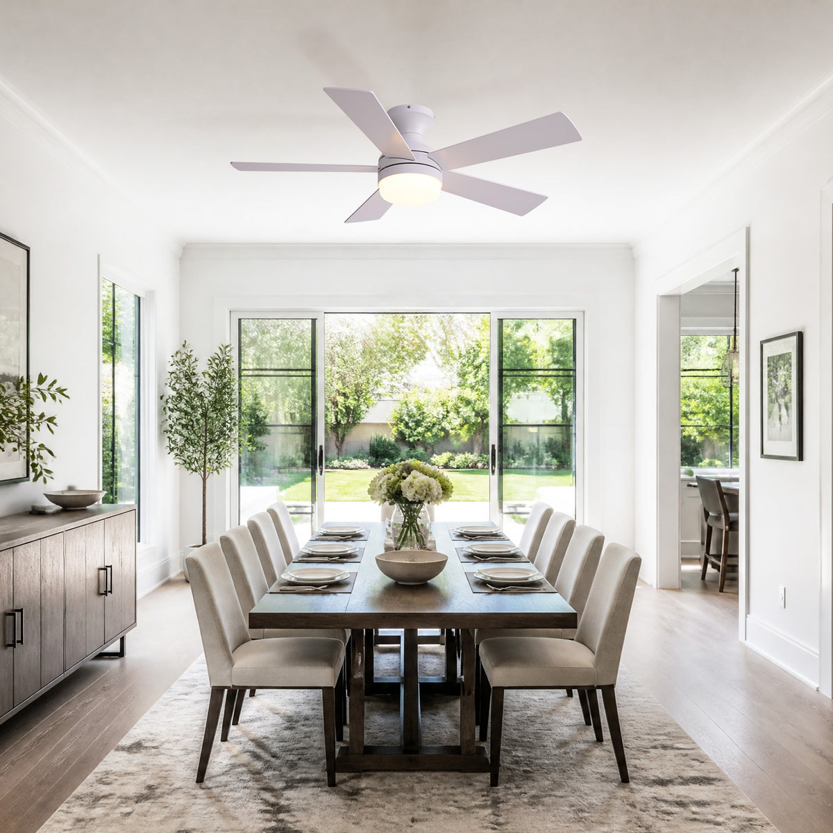 White flush mount fan in dining room — wooden dining table, upholstered chairs, glass doors, elegant modern dining space | Sofary Lighting