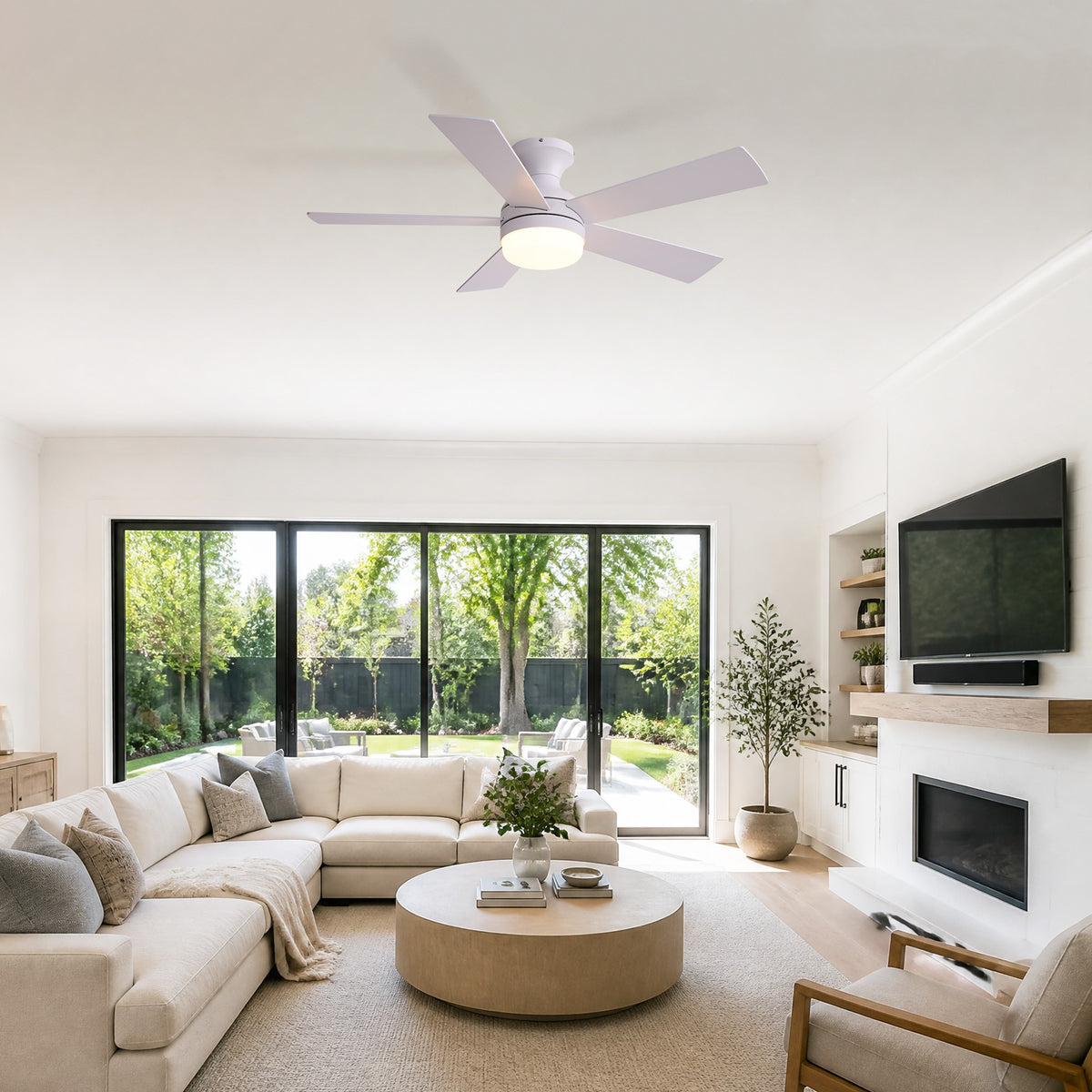 Modern white ceiling fan in living room — beige sectional sofa, large windows, fireplace, round coffee table, bright modern home decor | Sofary Lighting